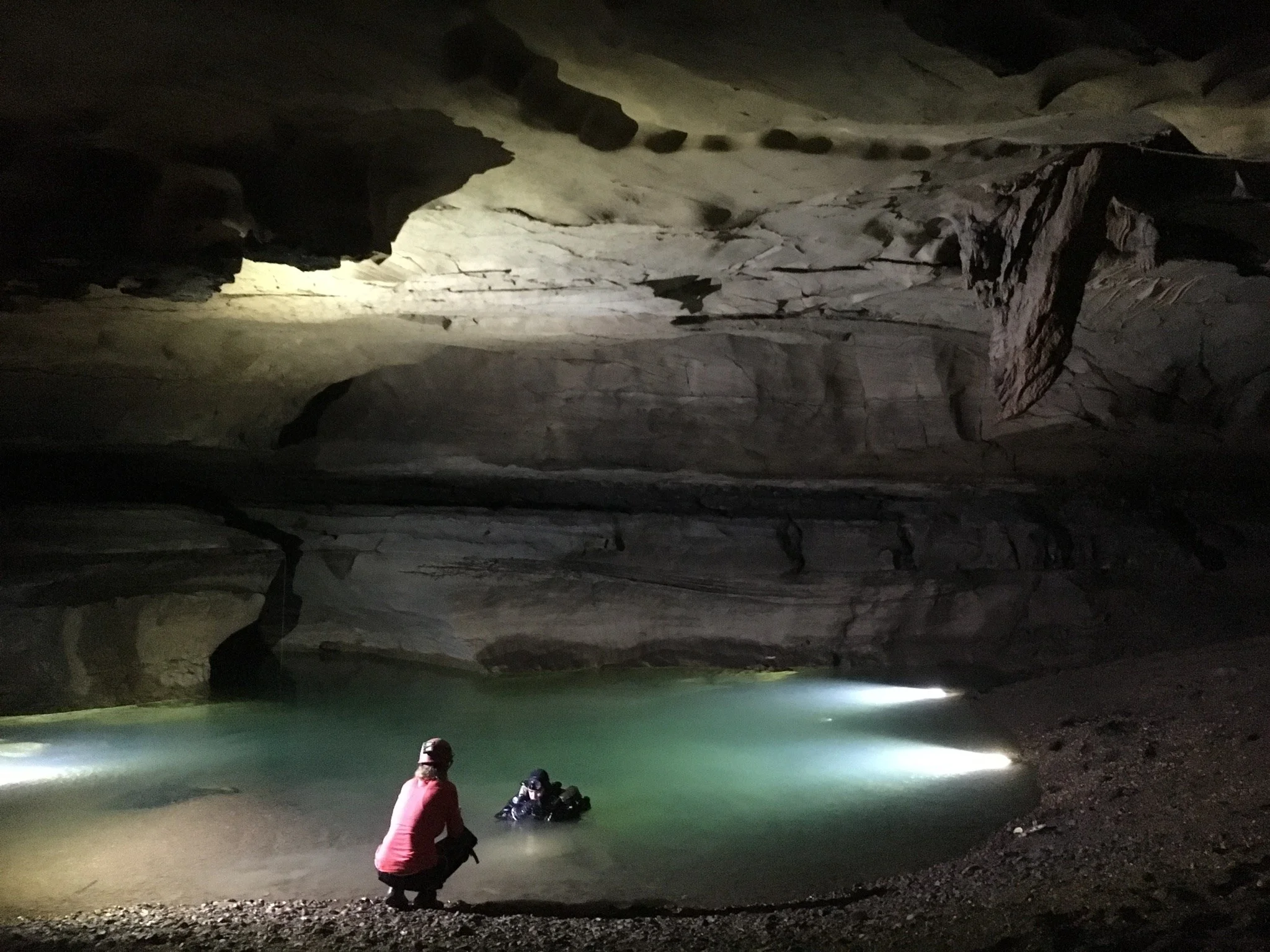 Chrissy Richards helps Jason Richards prepare for the dive in Montague Cave. Photo: Liz Hoffman