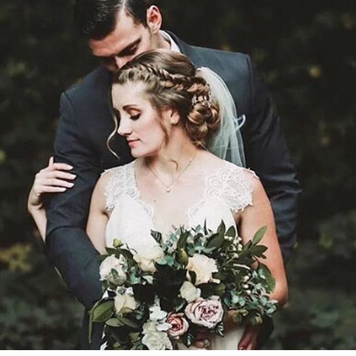 Braided Bridal Updo Hairstyle Low Bun Curls.jpg