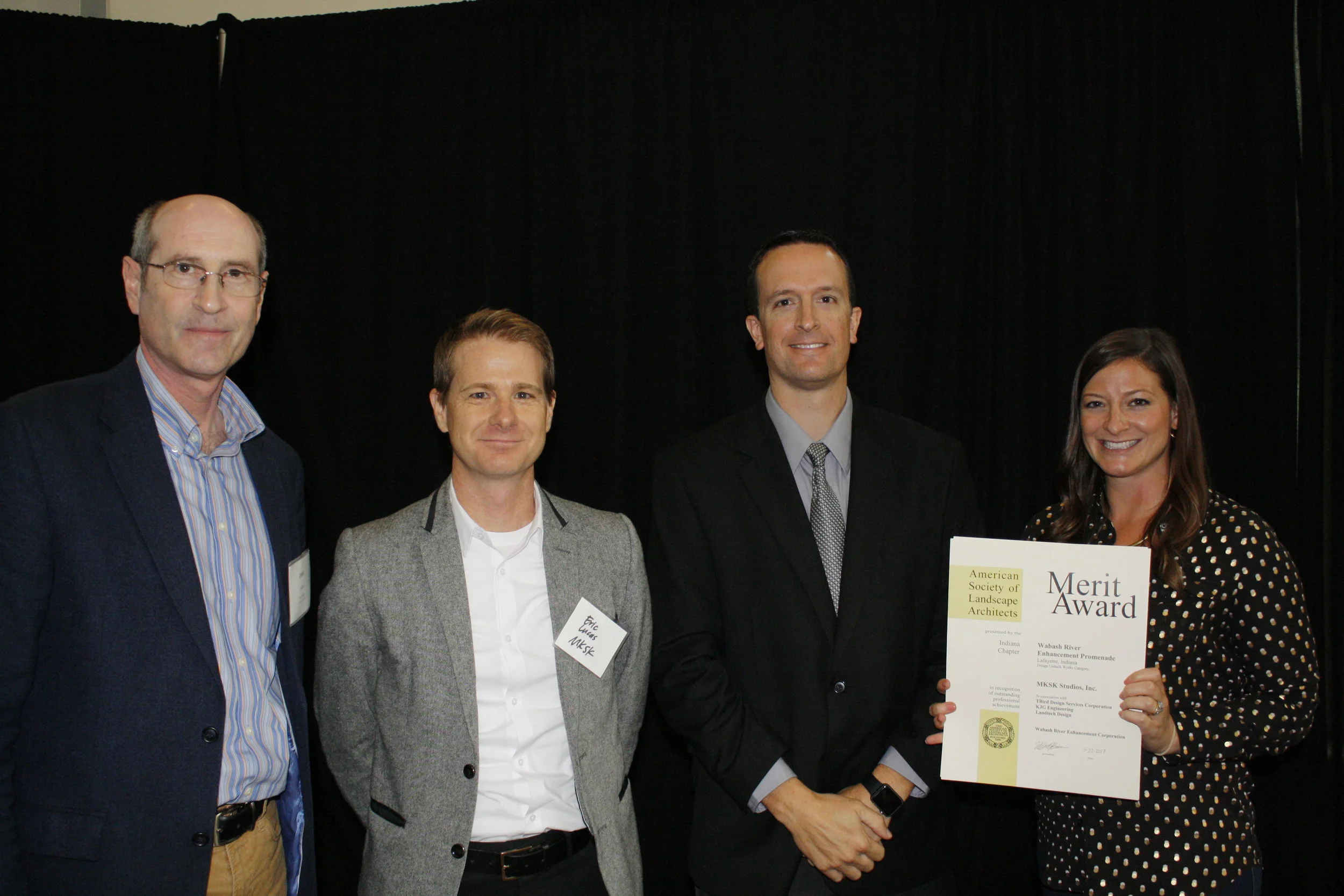 John Collier (Lafayette Assistant Director of Economic Development), Eric Lucas (Principal Landscape Architect, MKSK) and Julie Barnard (Landscape Architect, MKSK) receive the Merit Award from Bill Kincius (INASLA President)