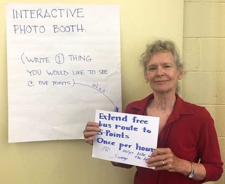 Area resident participates in an interactive photo booth activity.