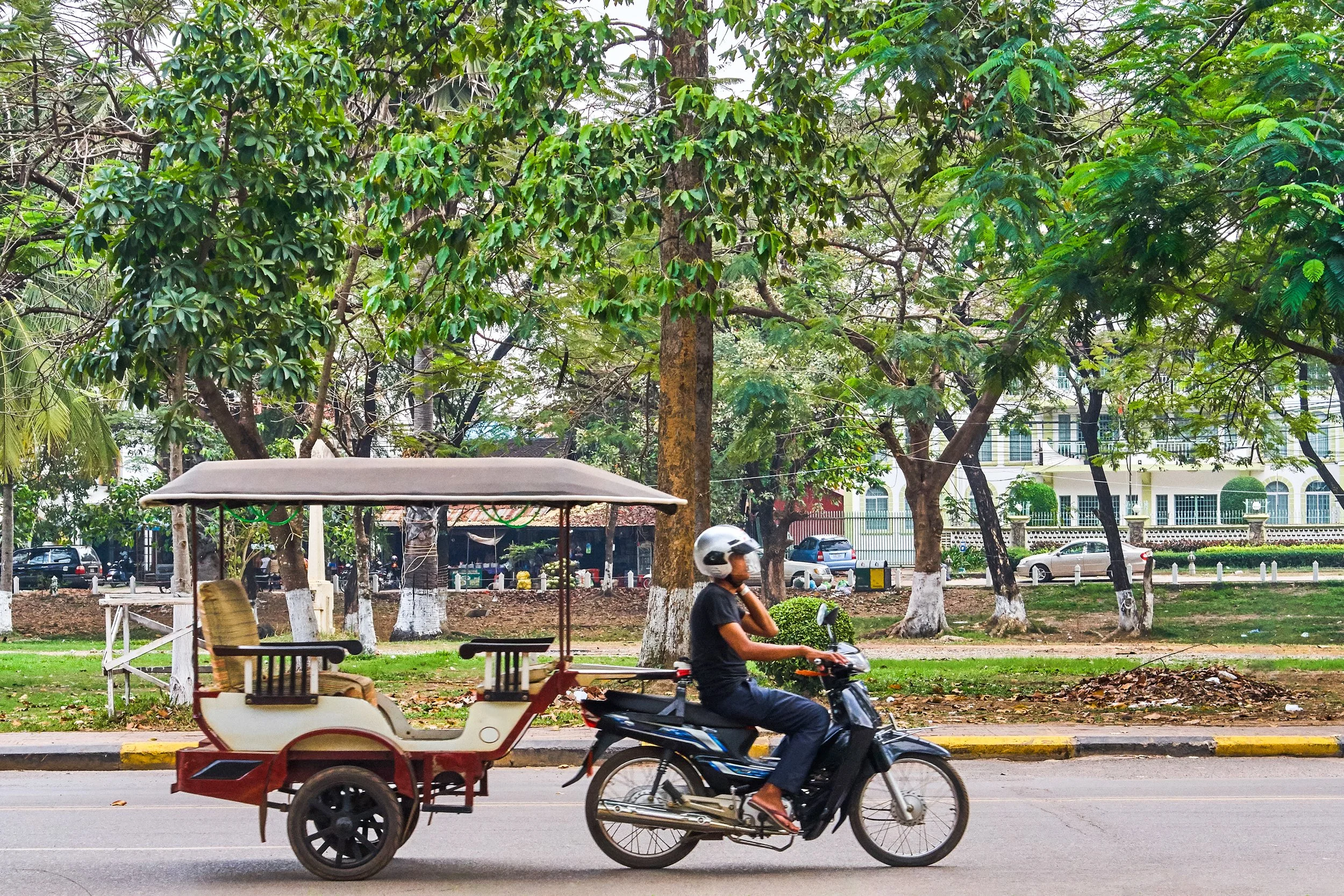Tuk Tuk driver on the road in Siem Reap, Cambodia.jpg