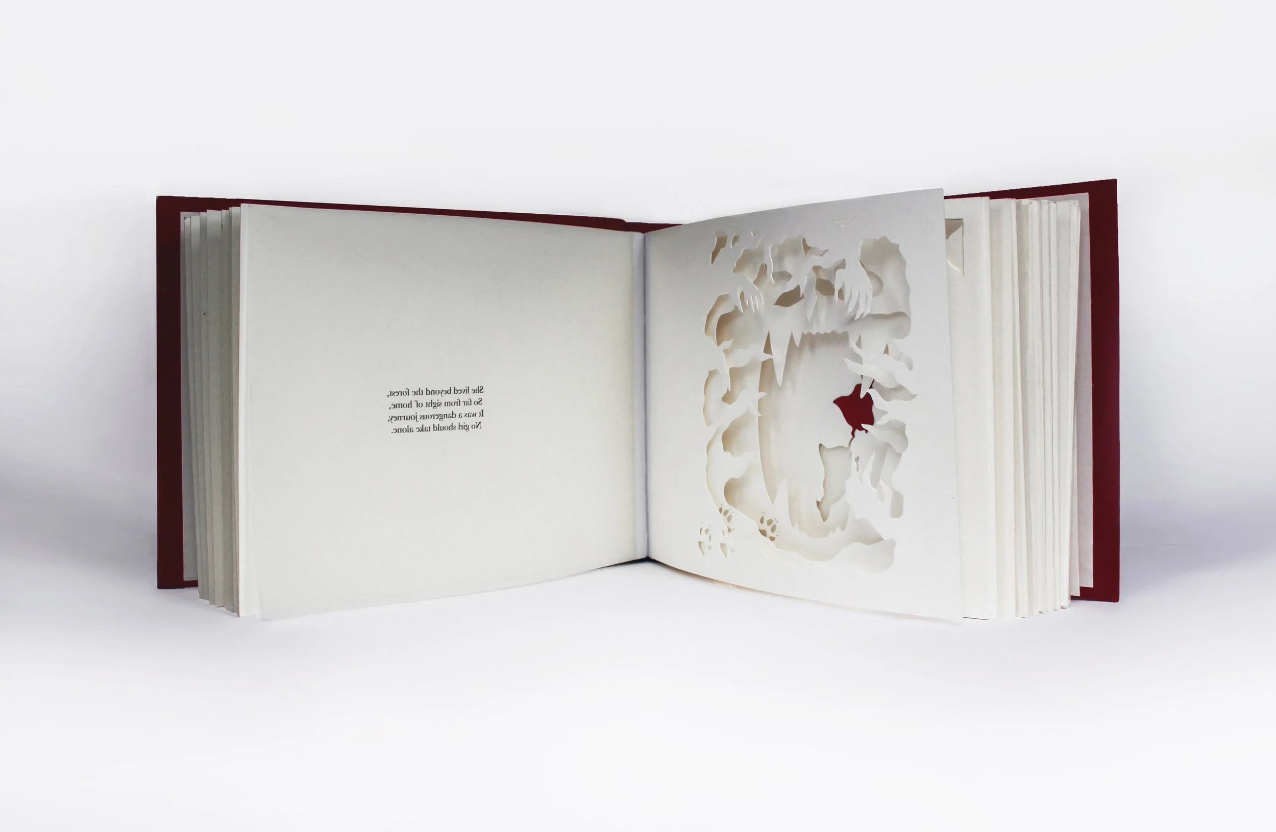 hand cut and bound peep-through book depicting the original story of little red riding hood