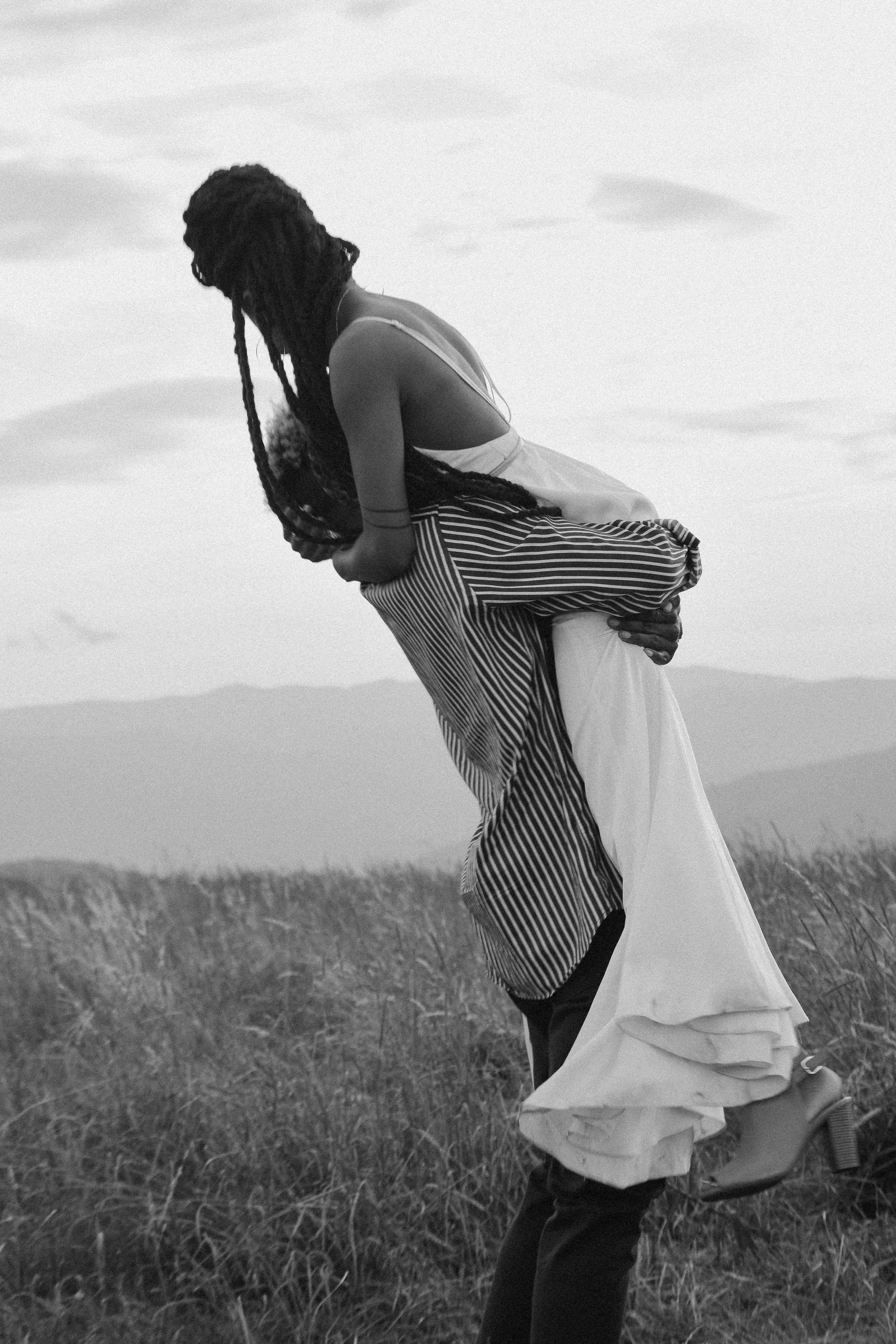  A groom holds his bride high up in his arms as they enjoy some quiet time together during their elopement in North Carolina 