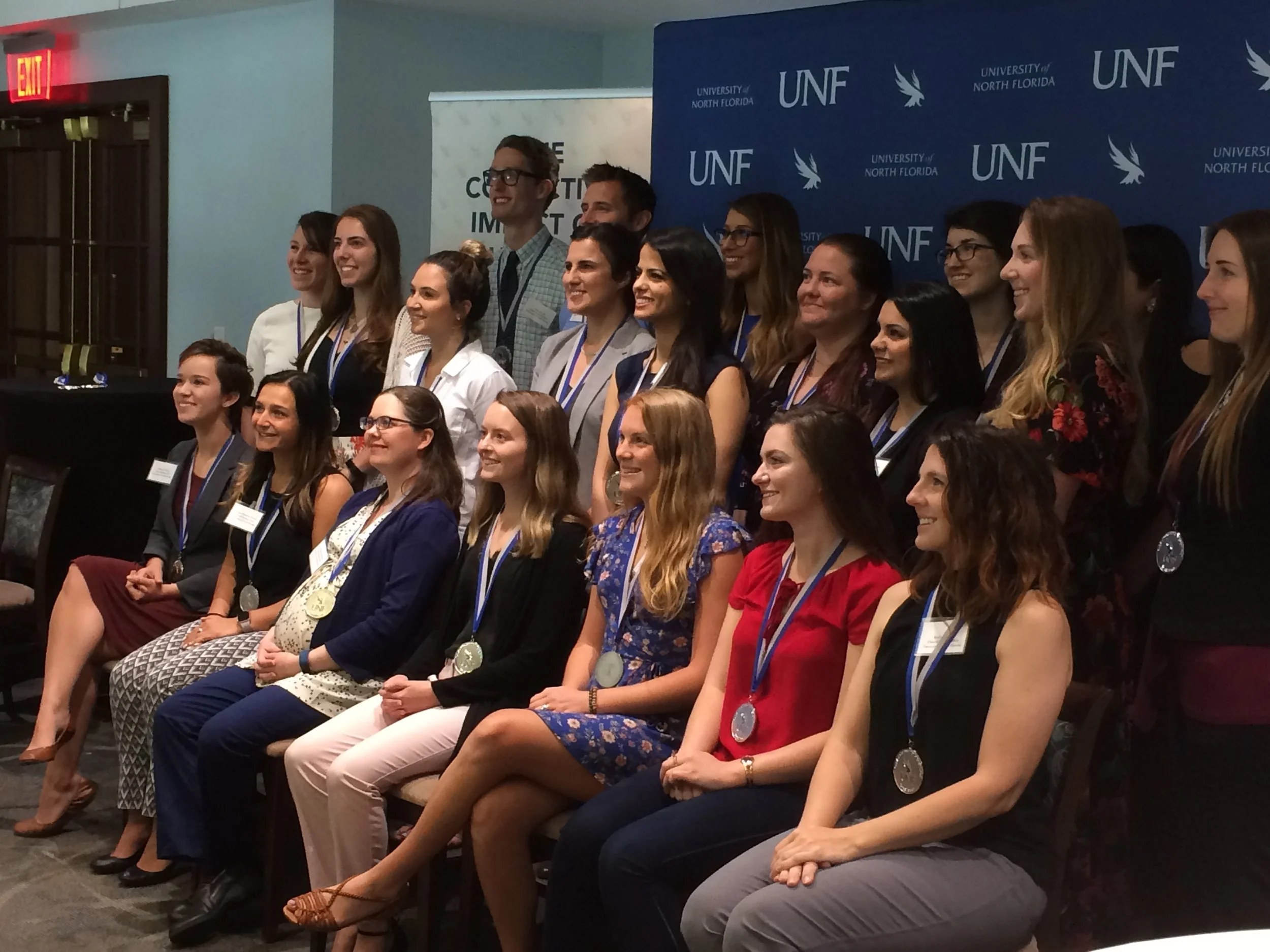 Rebecca Cheney receiving a medallion for her Healthy Choice food labeling system project at the University of North Florida's Osprey Community Engagement Medallion Awards Ceremony.