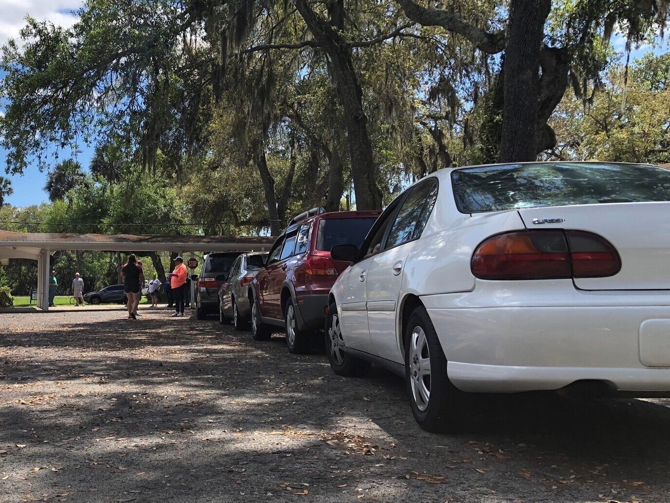 The beginning of a line of cars wrapping around Oak Harbor Baptist Church parking lot in Mayport, as clients wait for the BEAM Mobile Food Pantry to open to customers. Cars were backed up on A1A, eager to receive meals for their families effected by…