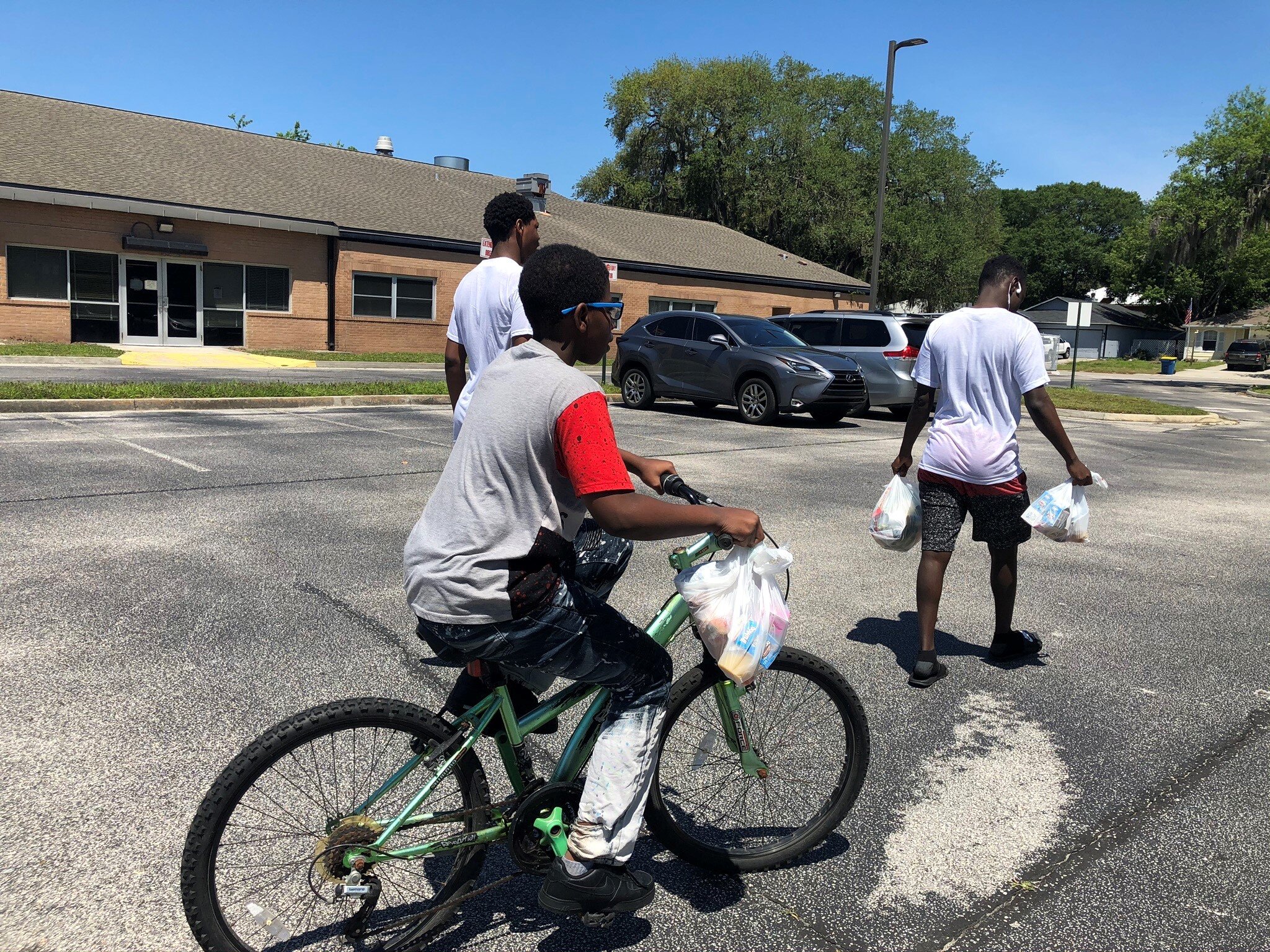 A student and his older brothers pick up groceries from BEAM after grabbing their lunch from Mayport Elementary School.