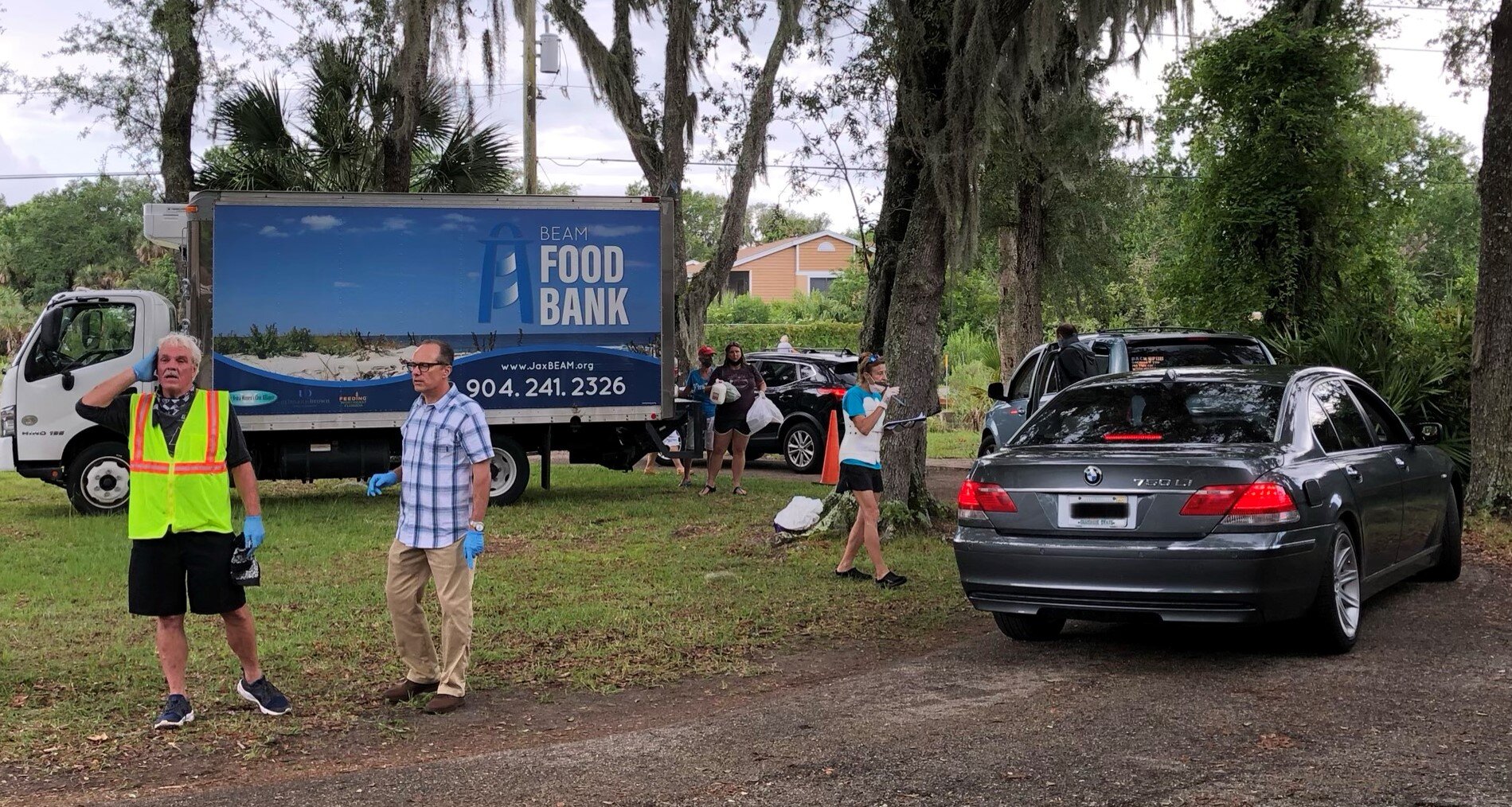Oak Harbor Baptist Pastor David Tarkington directs cars during the Oak Harbor Food Distribution last week.