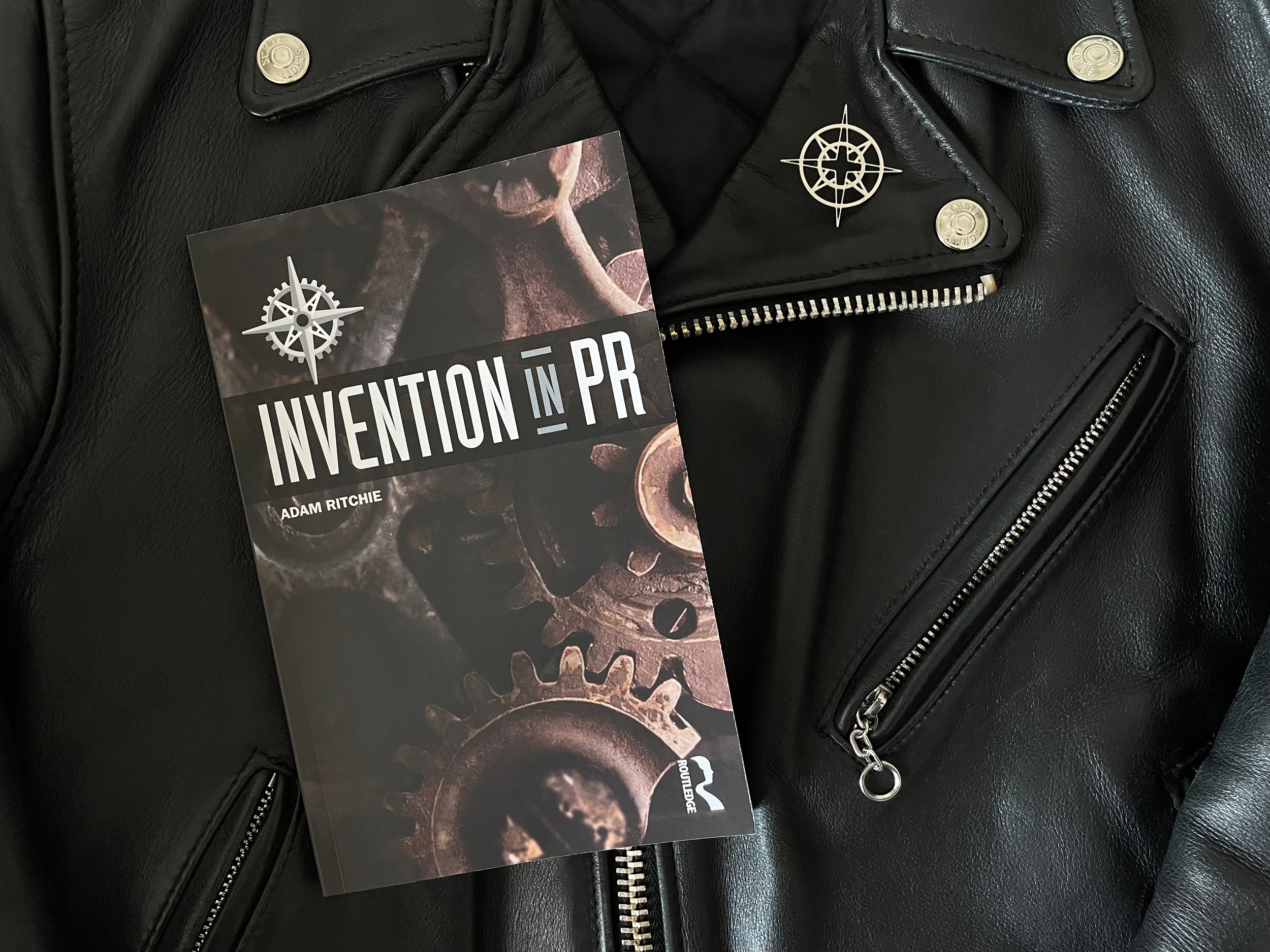 "Invention in PR" book flatlay