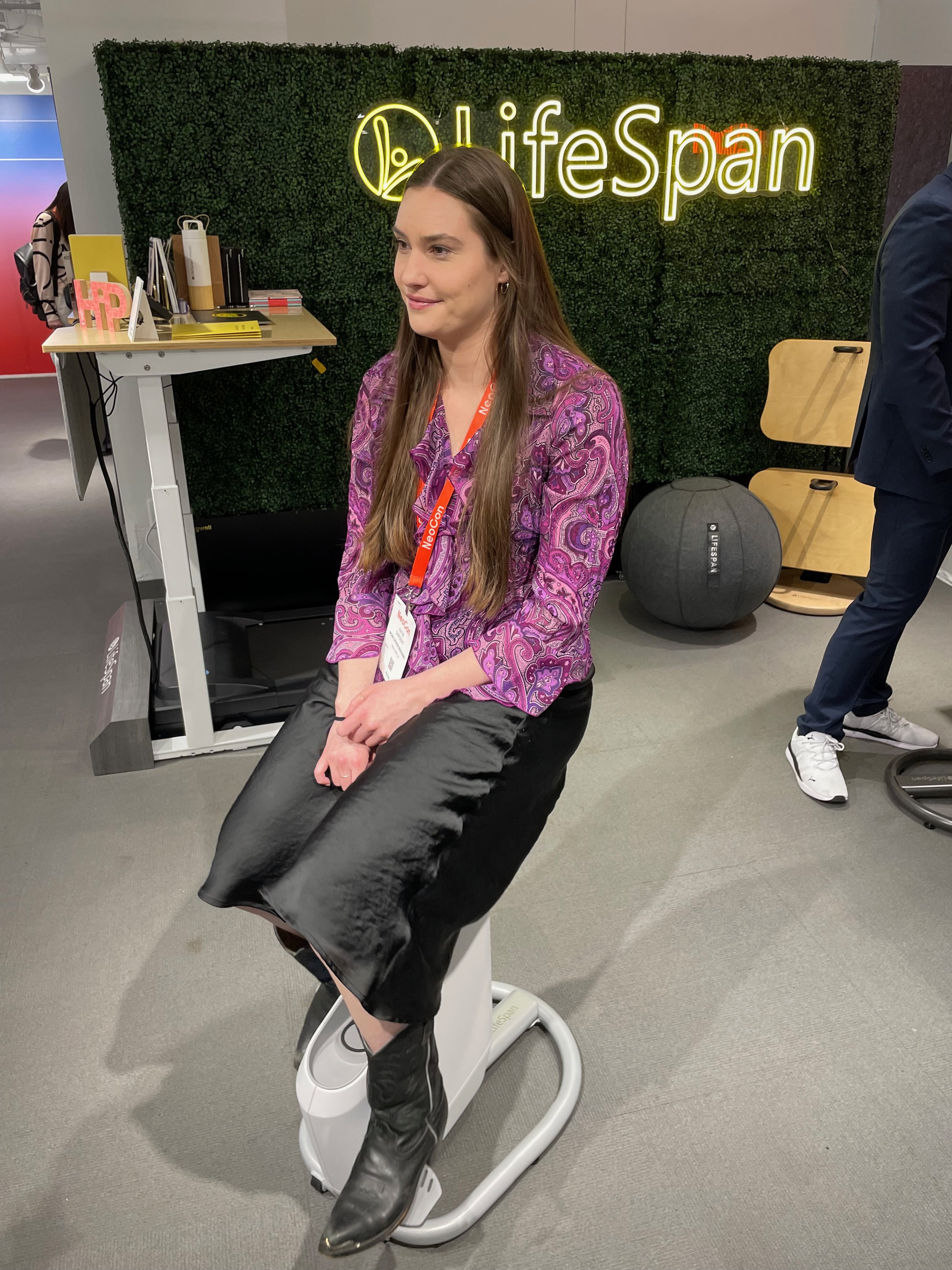 NeoCon 2023, Work Design Managazine demo'ing the Ampera Bike