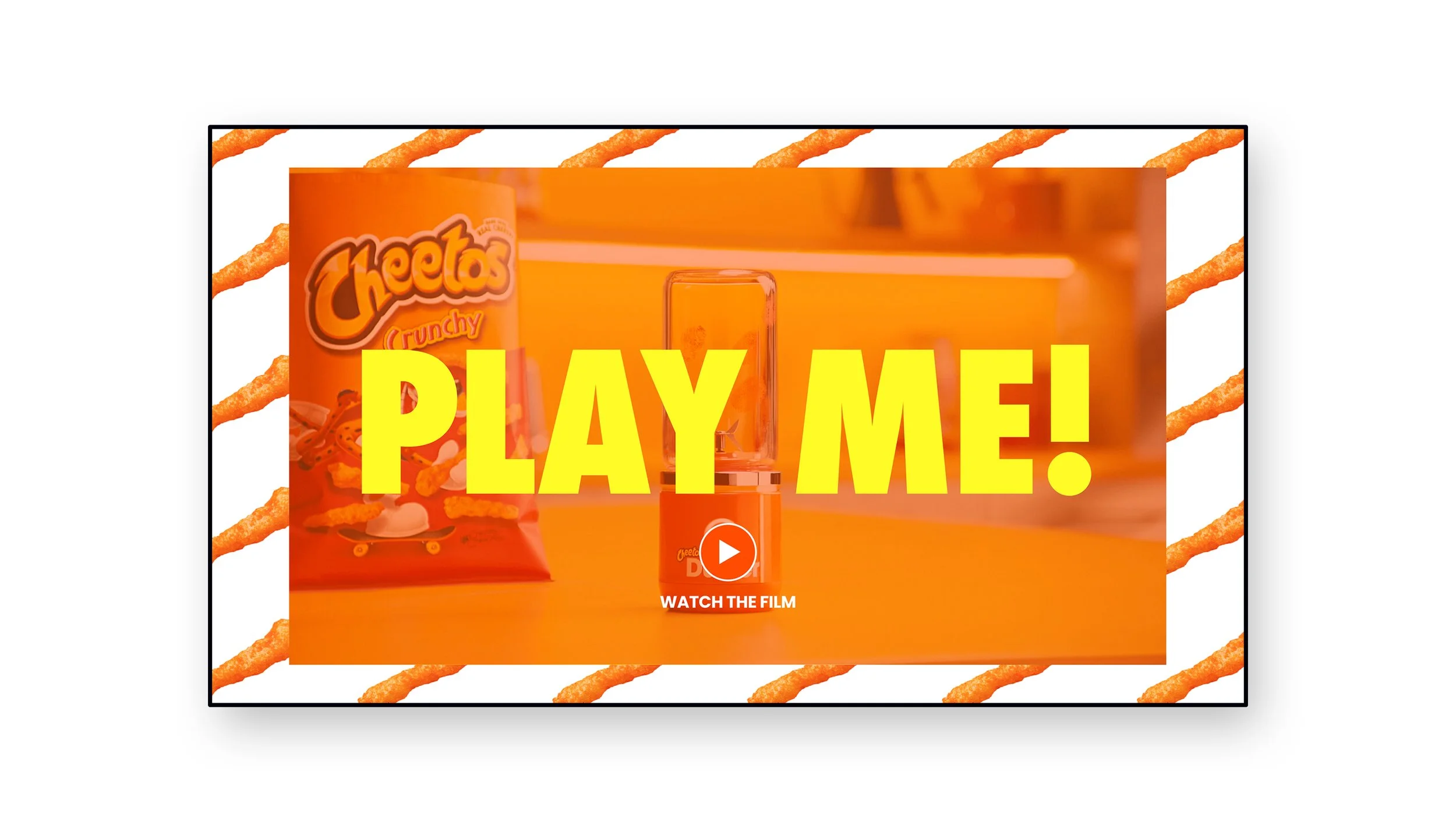 A promotional screen with an orange background featuring a bag of Cheetos Crunchy, a small spray bottle, and large yellow text that reads 'PLAY ME!'. There is a white play button icon with the text 'WATCH THE FILM' below it.