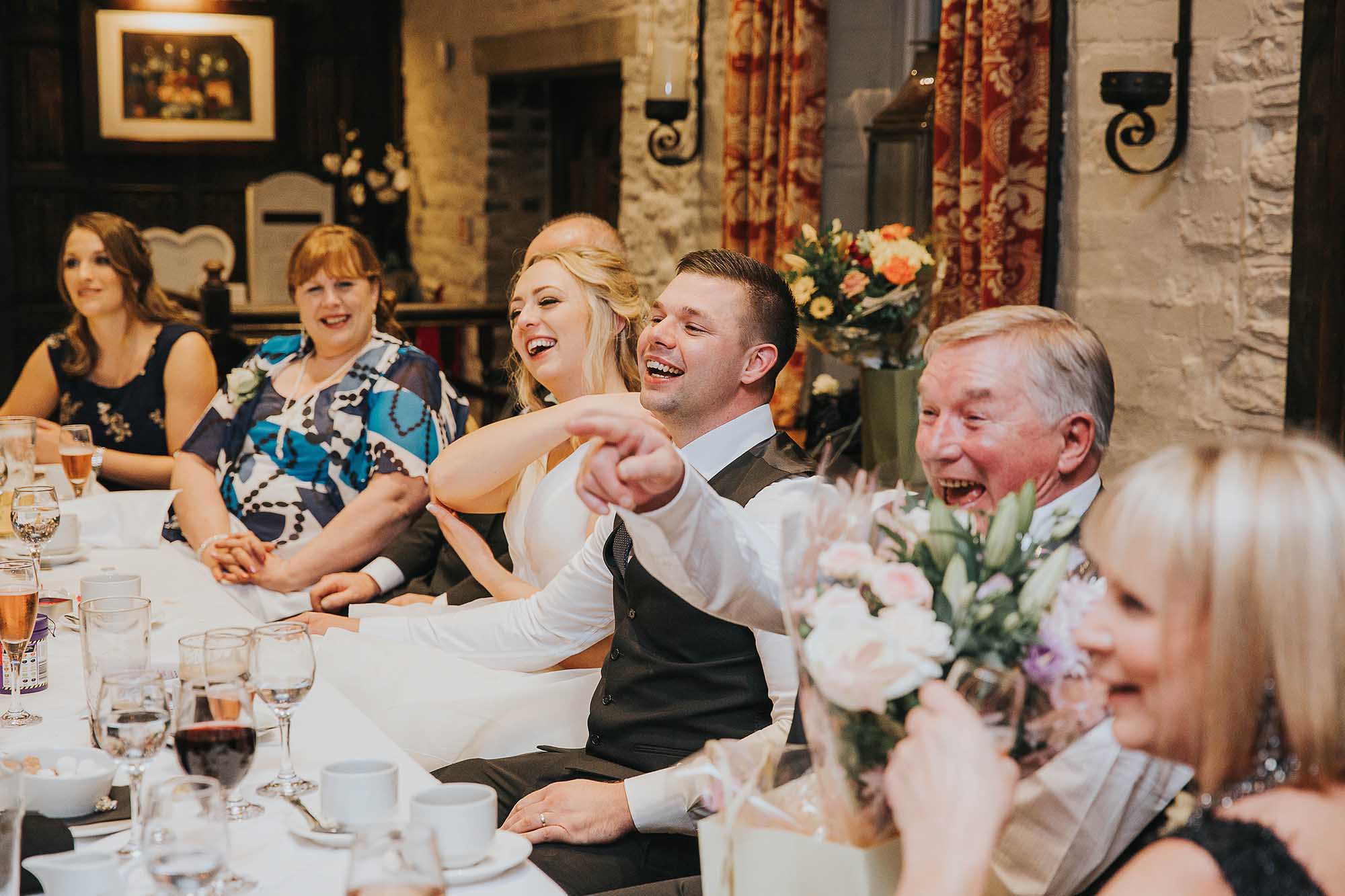 bride and groom laughing at their speeches at Holdsworth House