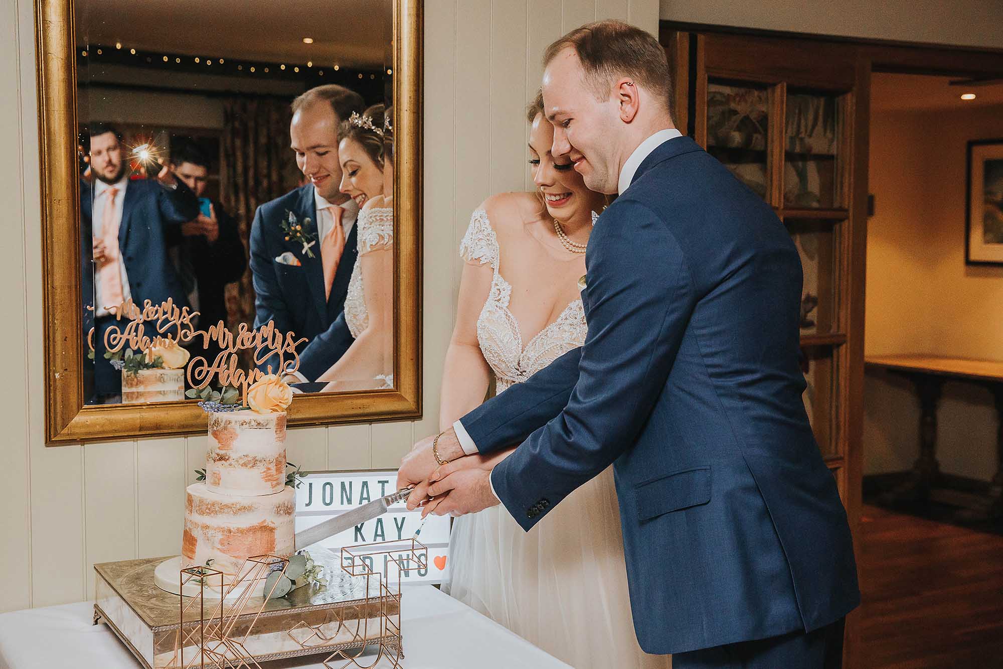 bride and groom cut the cake at The Black Swan Helmsley