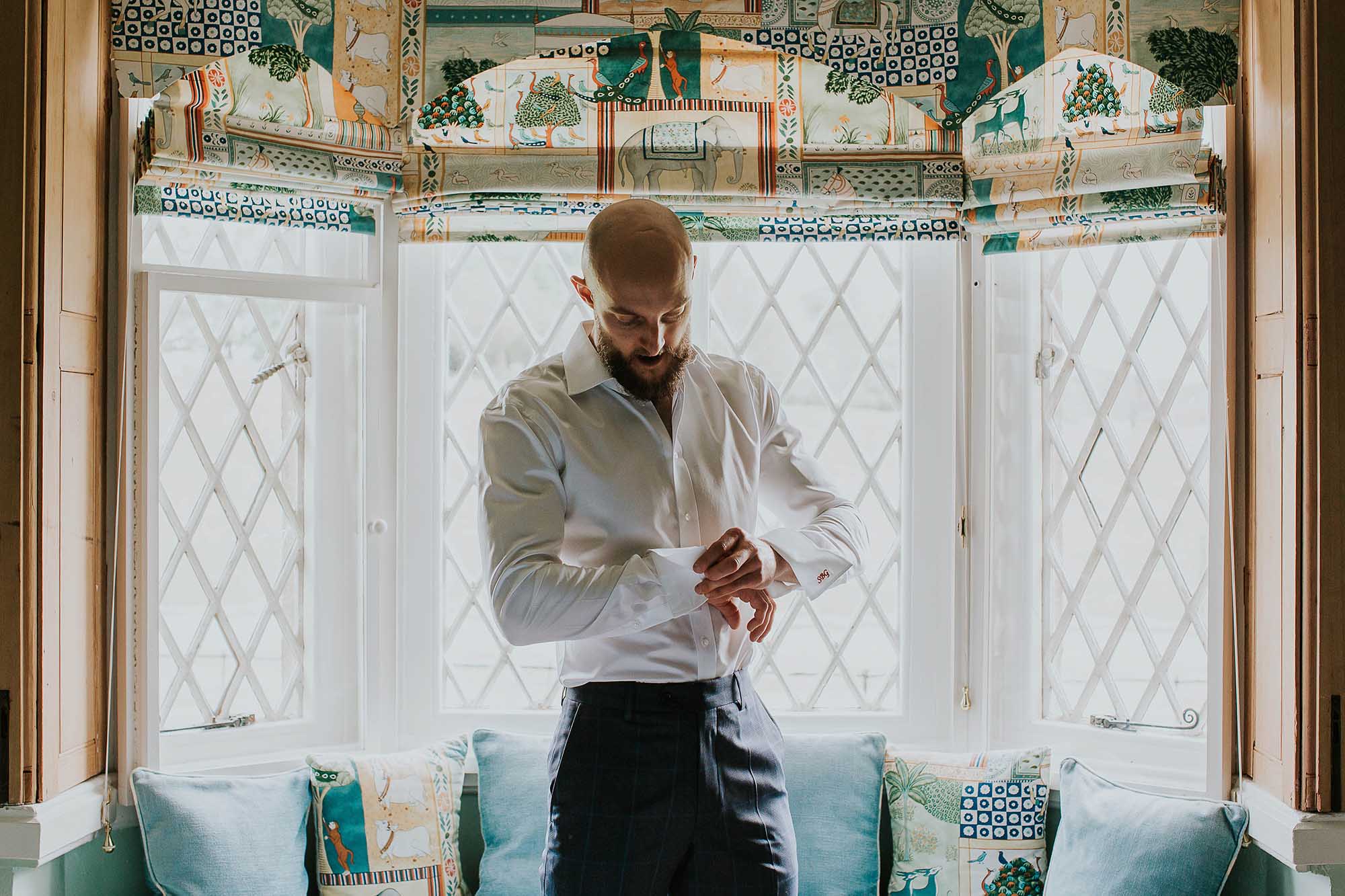 groom getting ready in a cottage at Combermere Abbey