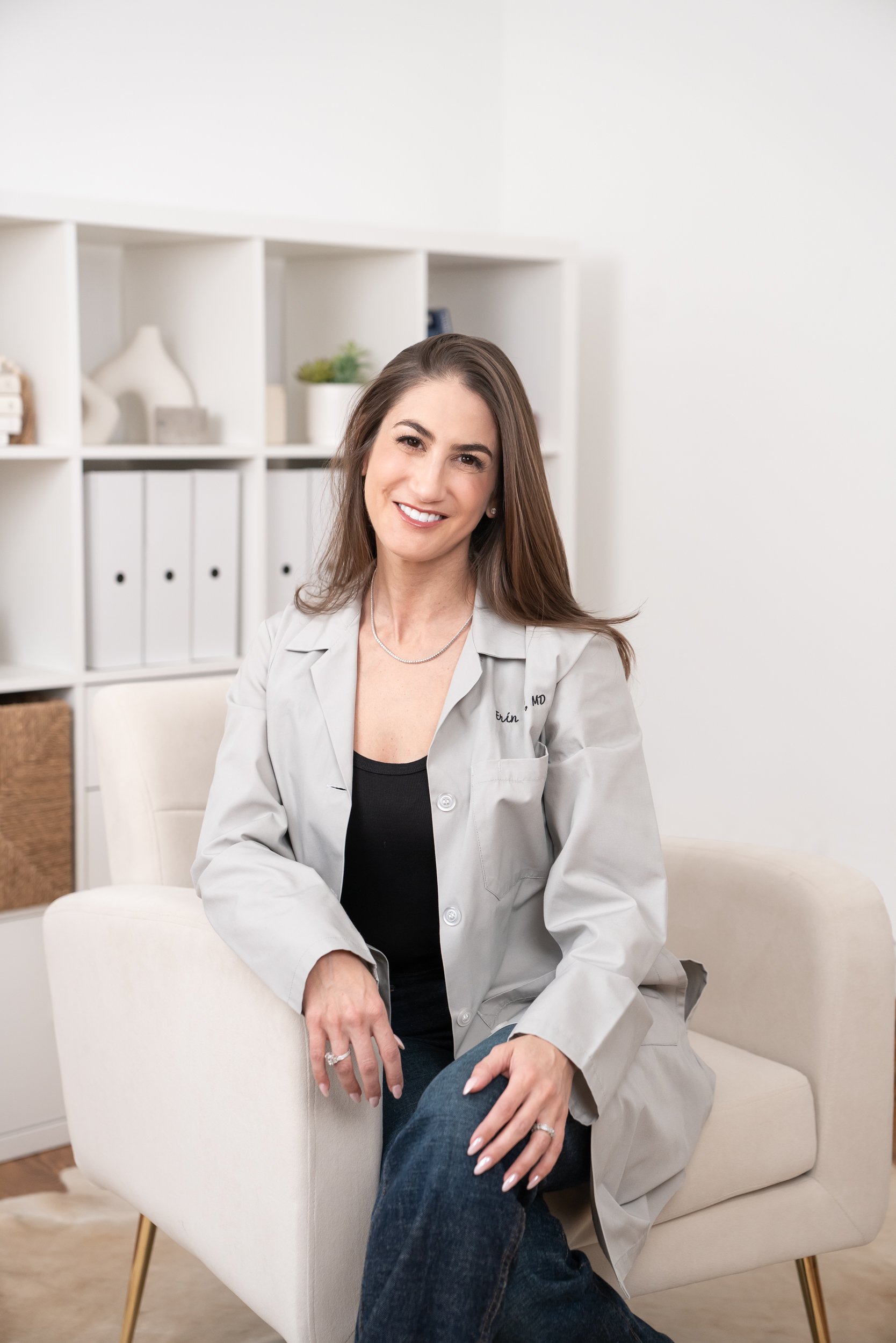 female physician seated in a chair in her home office
