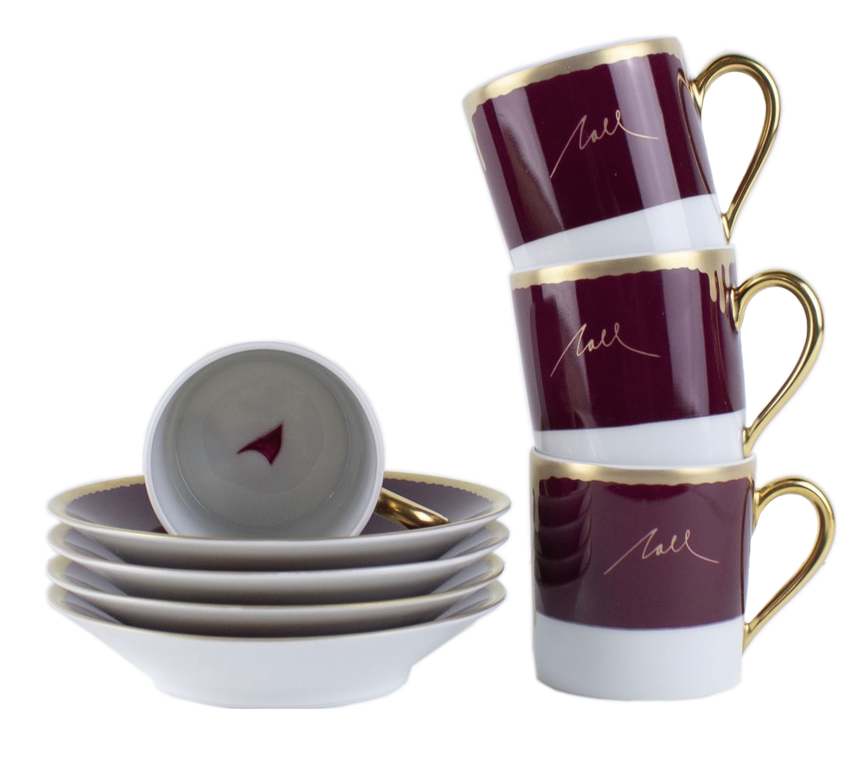 A set of stackable cups and saucers with a deep burgundy, white, and gold design. The cups have a gold handle and interior, with the exterior featuring a burgundy band and a gold signature-style script. Several cups are stacked, and a few are placed on matching saucers, all against a black background.