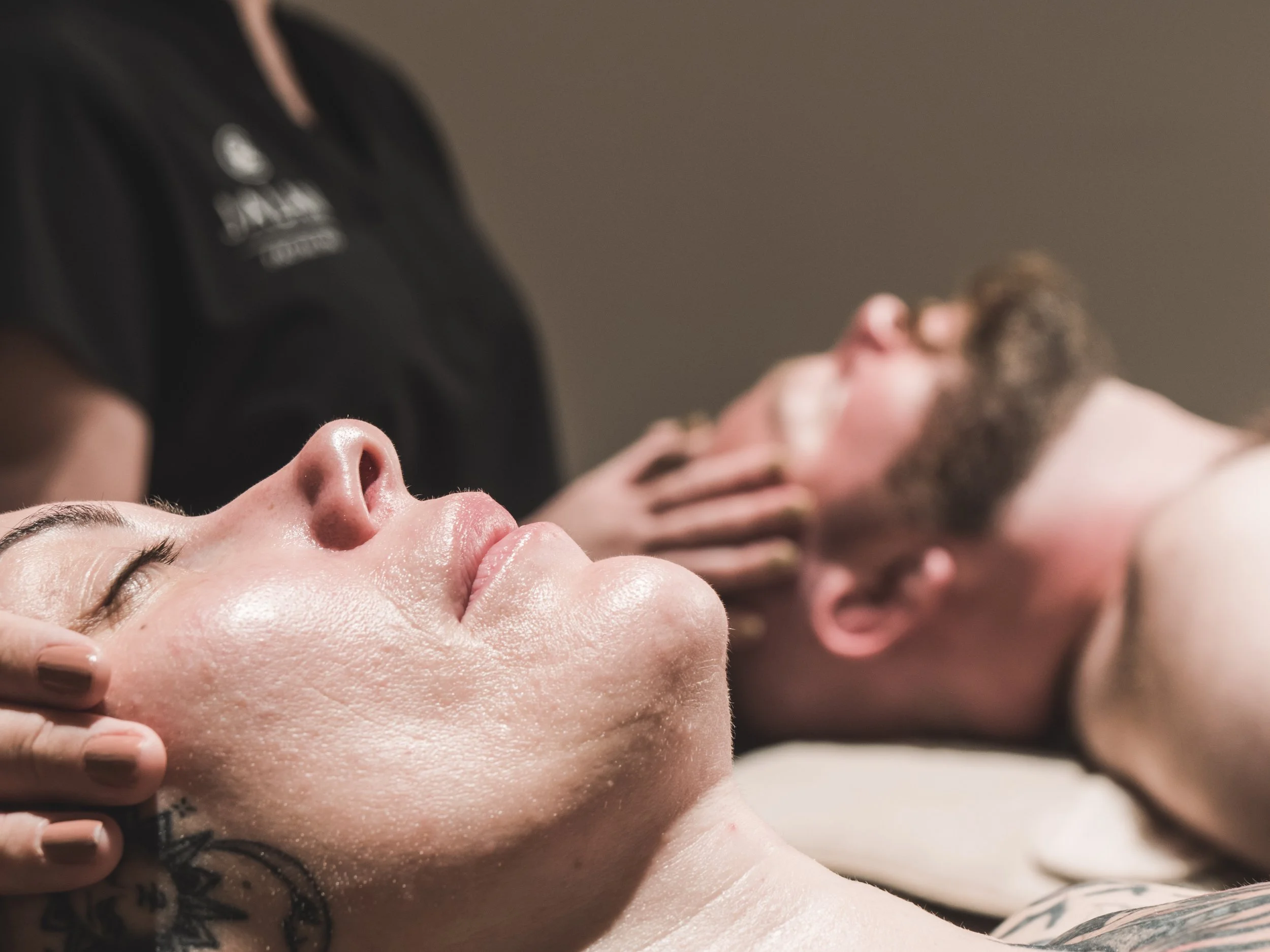 Couple receives facial massage in treatment room at Jalan Facial Spa - Greenwood Village