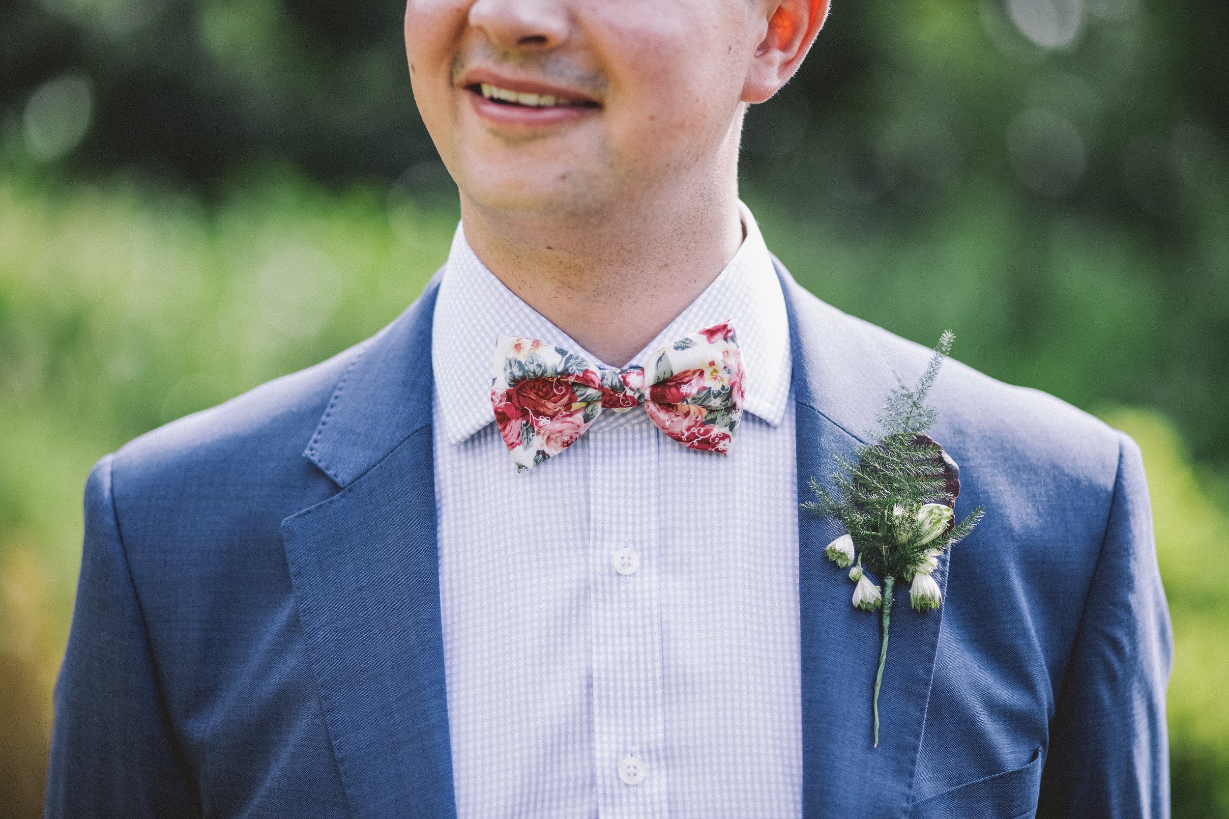 Groom with a colorful bowtie in a blue suit