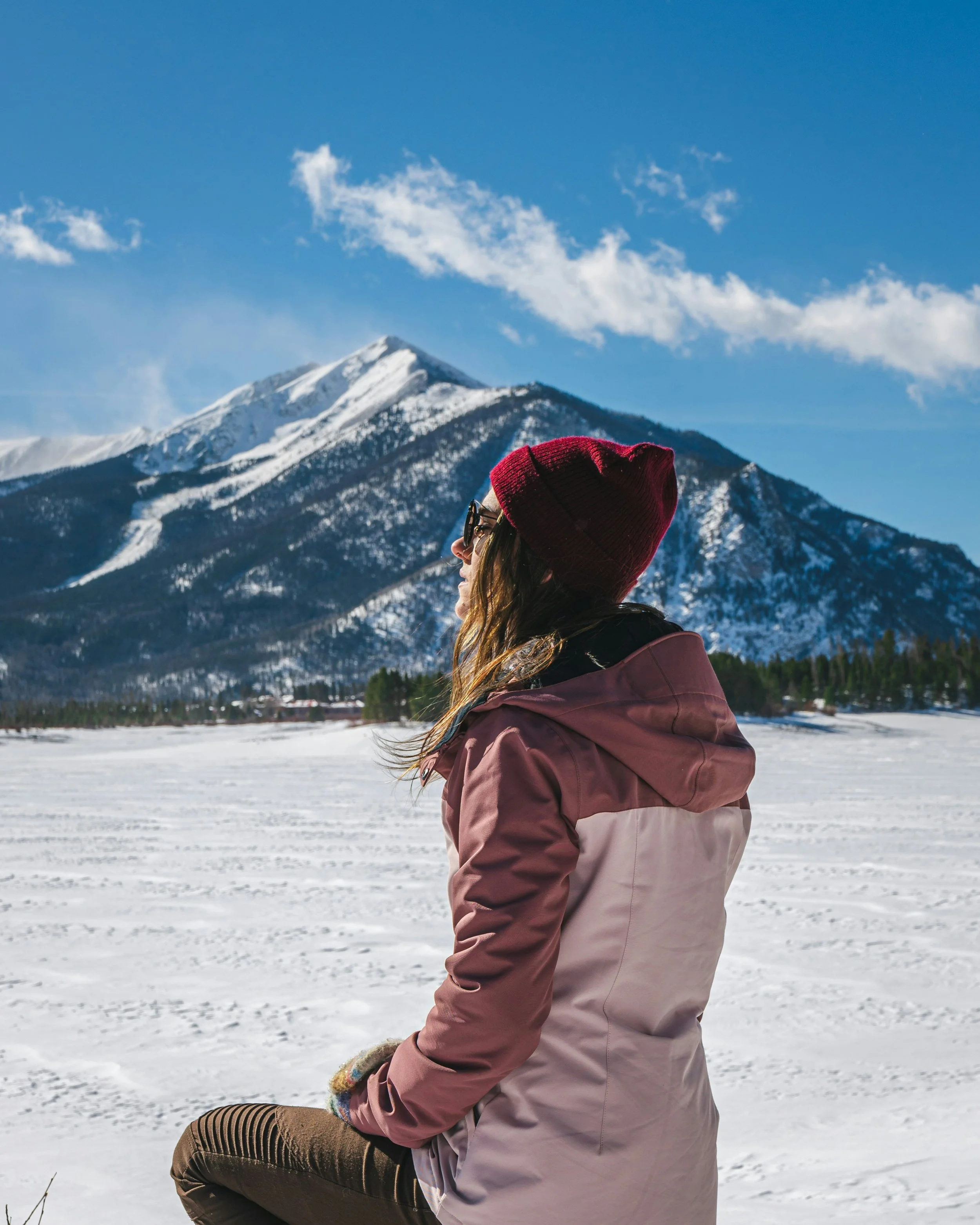 Woman in Rocky Mountains skiing and ready for spa treatment to heal skin at Jalan Facial Spa