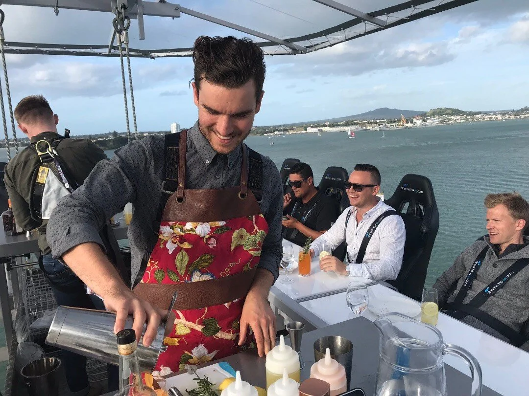 Early evening cocktails in the sky with master mixologist Logan Demy. #dinnerintheskyanz