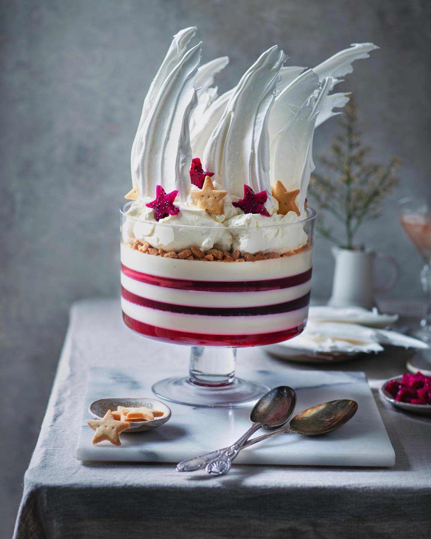 A whimsical Xmas striped trifle- part jelly bowl, part trifle, with cream clouds and meringue wings. 
The bowl is filled with raspberry jelly and cinnamon and vanilla spice milk jelly, a little shortbread crumble, vanilla Chantilly cream, meringue an