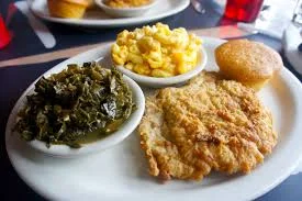Fried fish, collard greens, macaroni and cheese and a cornbread muffin are staples of soul cuisine.