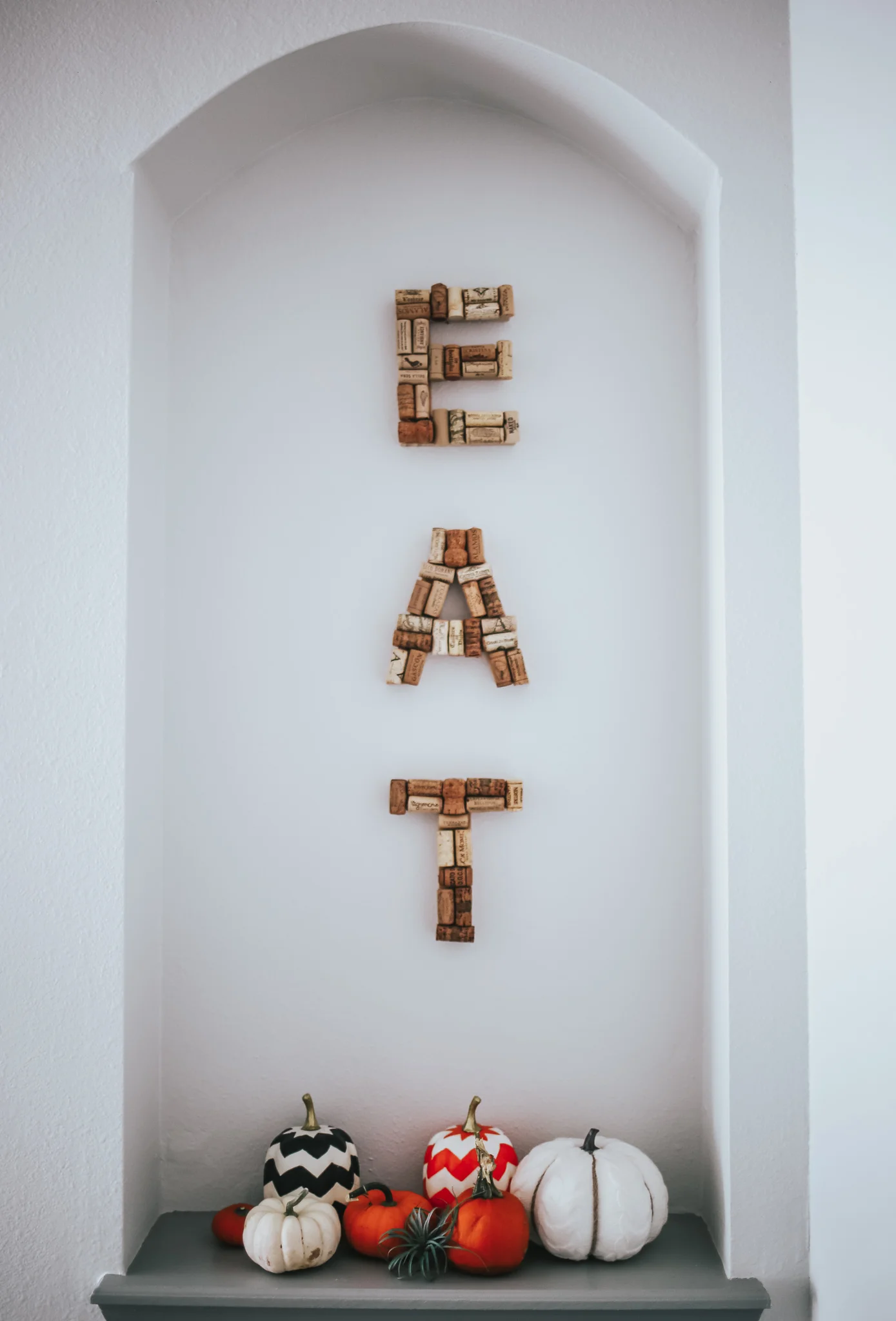 we have a built in space in this area that I will probably decorate seasonally. or fill with pictures frames of family. I made this “eat” sign a few years ago! i just purchased wooden letters from hobby lobby and hot glued on corks i collected.