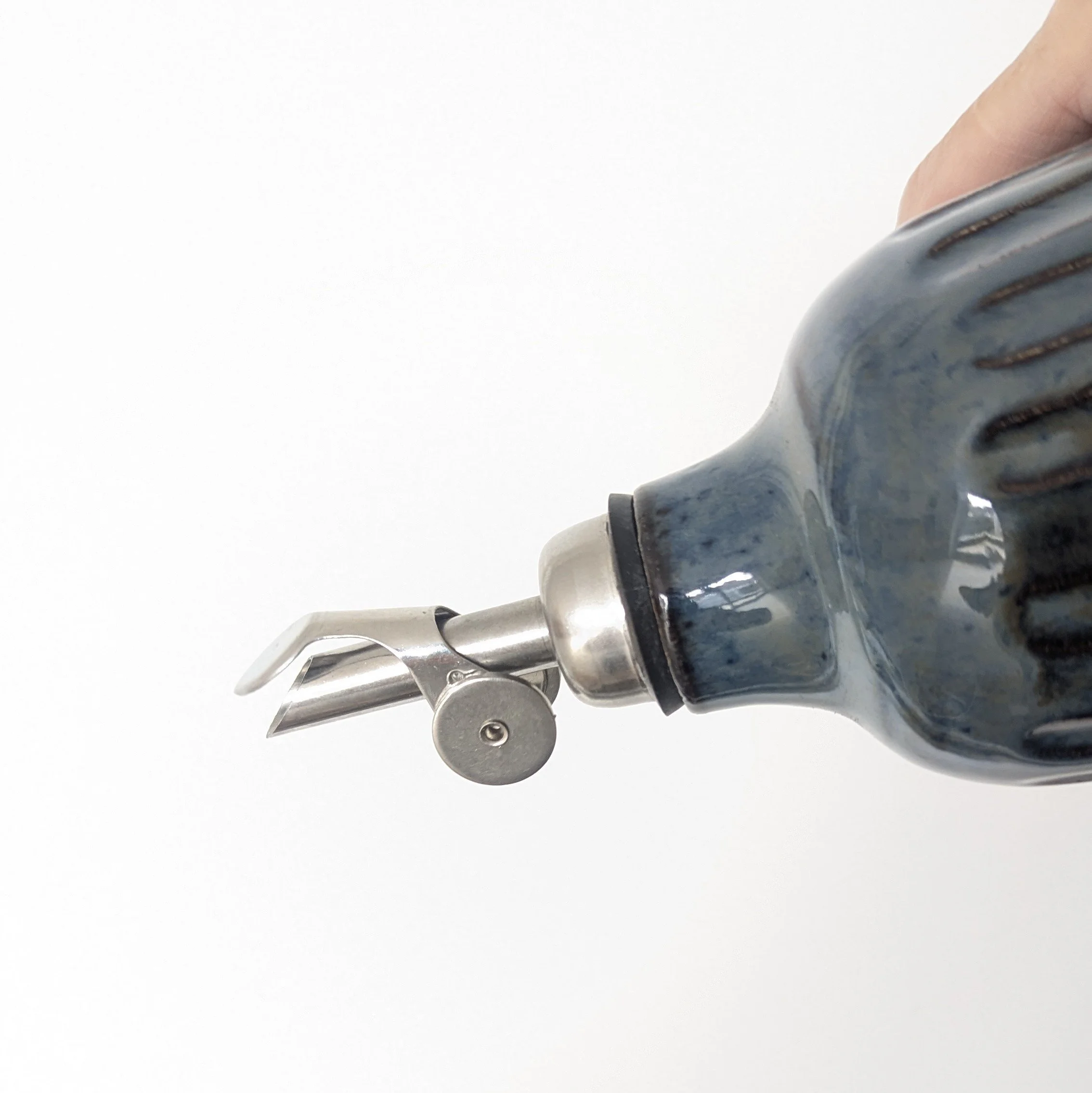 Ceramic oil bottle handmade with spout that automatically opens when tipped