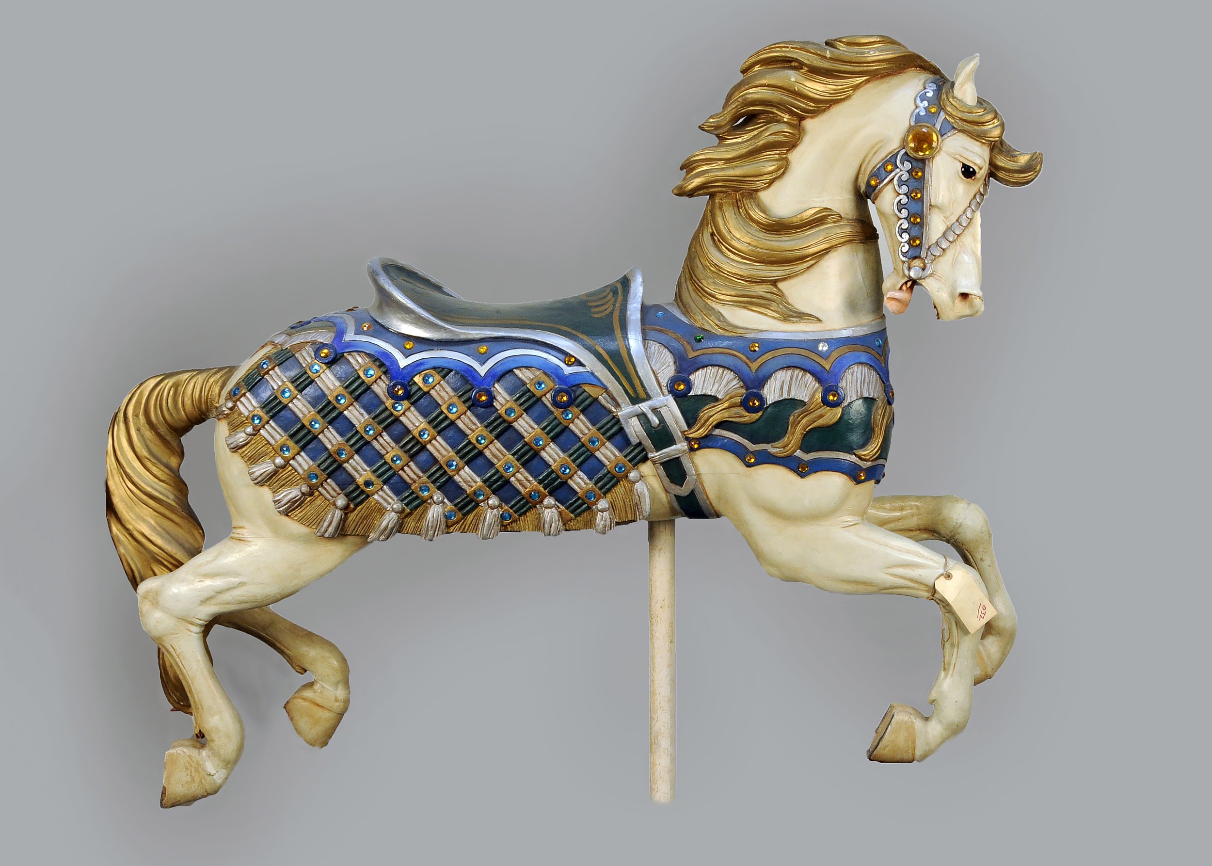  Charles Carmel (1865–1931),  Outer Row Jumper Horse , c. 1918, paint on wood with glass jewels and glass eyes, 51 x 63 x 14 inches. Collection American Folk Art Museum, New York. Gift from the collection of Larry and Gail Freels, 2020.1.4. 