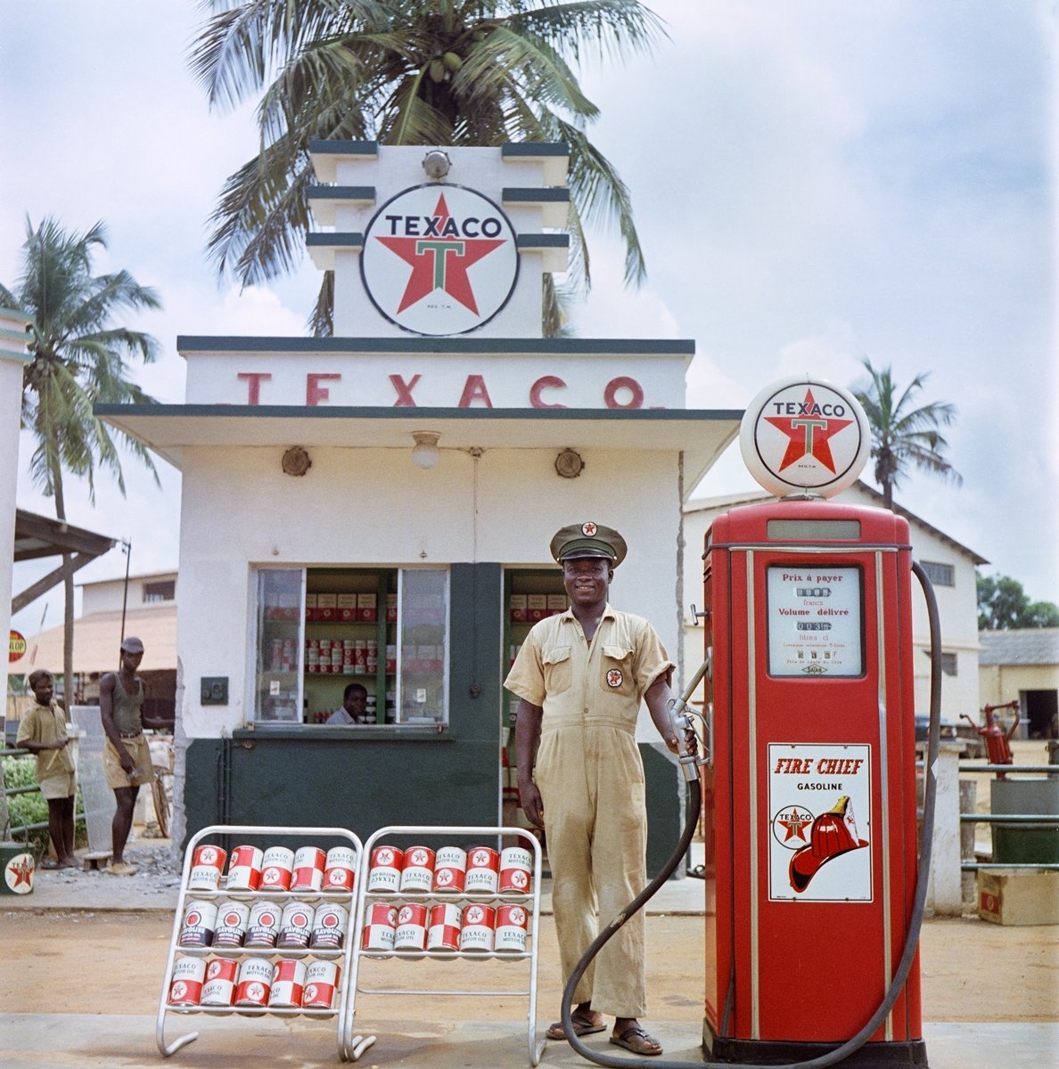  Todd Webb (United States, 1905-2000),  Untitled (44UN-8002-165), Togoland (Togo)  [Attendant at Texaco station], 1958, archival pigment print, 20 x 20 inches (image), 22 x 22 inches (sheet). © Todd Webb Archive 