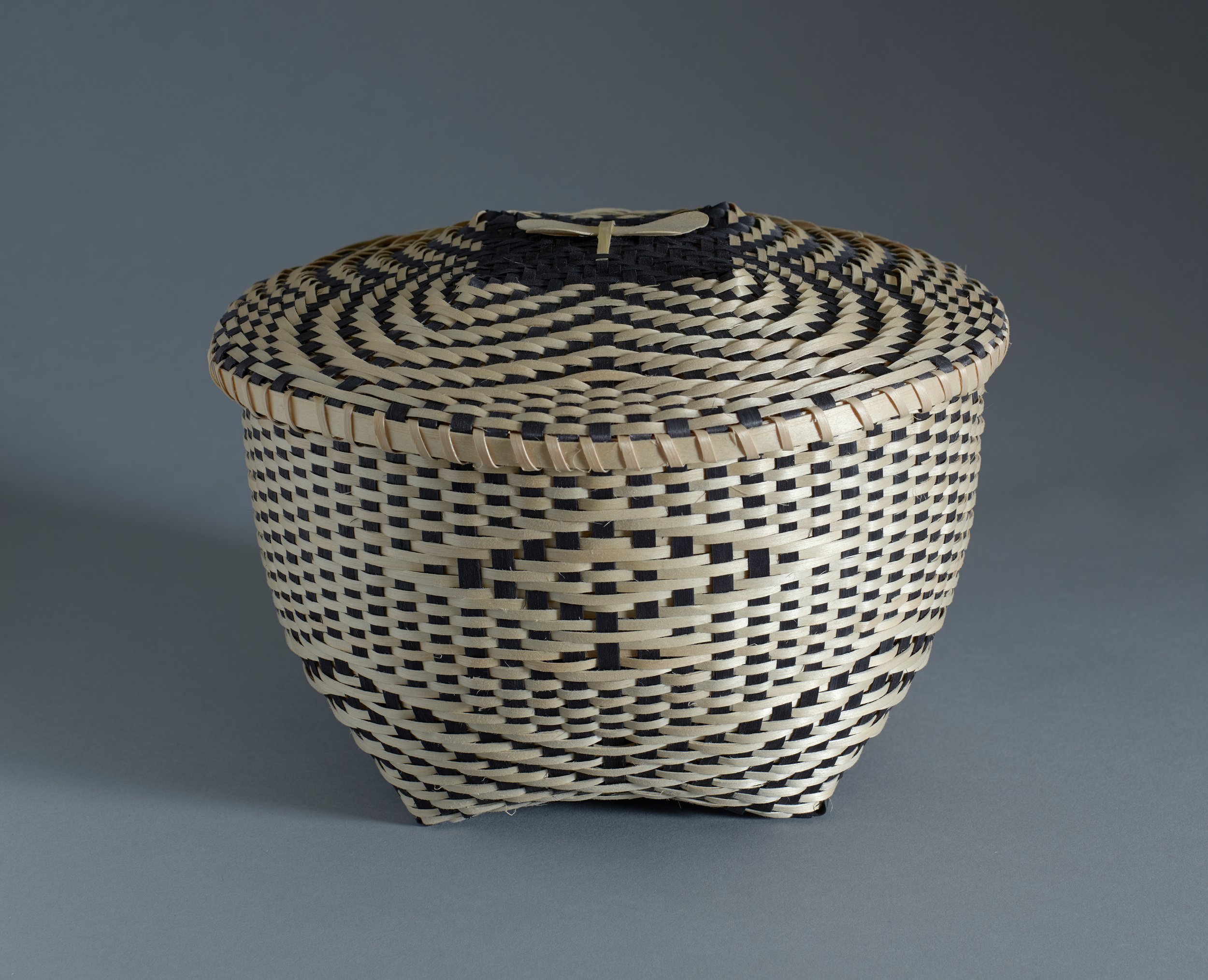  Fred Tomah (Maliseet, 1951–2018),  Arctic Katahdin butterfly basket,  circa 2010,     black ash, sweetgrass, and dye, 7 3/4 x 10 1/2 x 10 1/4 inches. Portland Museum of Art, Maine. Gift of Barbara M. Goodbody, 2021.19.14a,b. Image courtesy Luc Demer