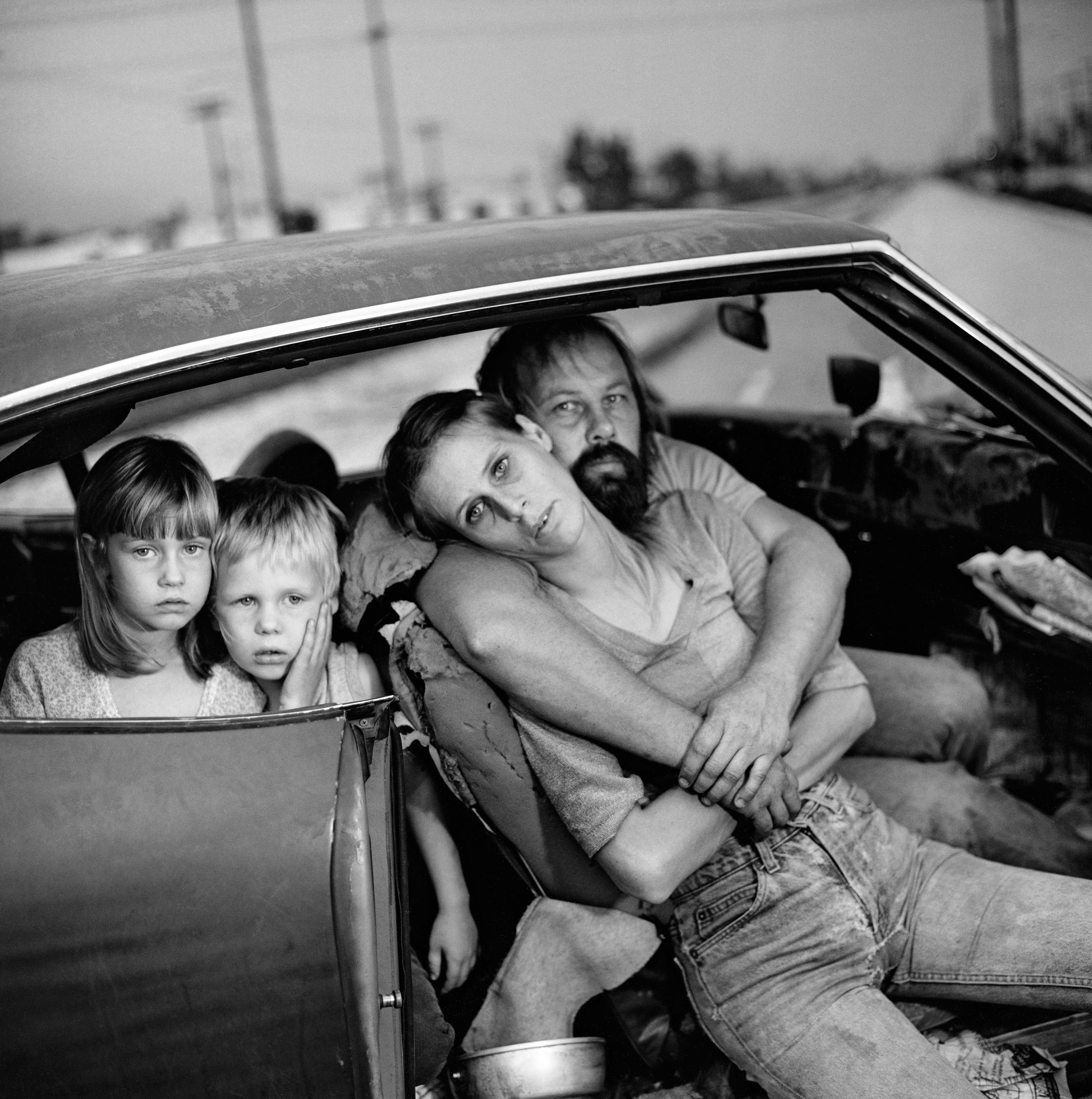  Mary Ellen Mark (United States, 1940–2015),  The Damm Family in Their Car, Los Angeles, California , 1987, gelatin silver print, 10 3/16 x10 1/4 inches. Portland Museum of Art, Maine. Gift of the artist for the Ernst Haas Memorial Collection, 1998.7