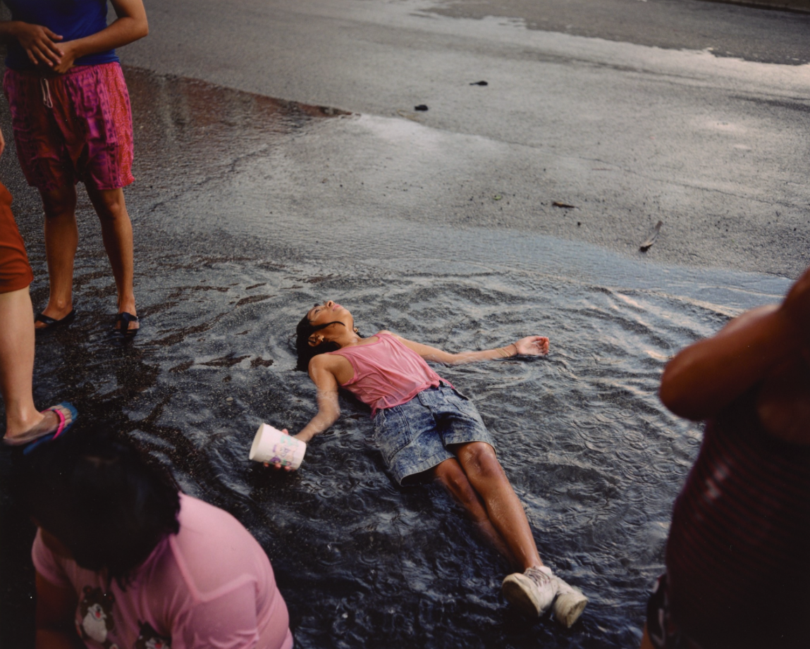   Paul D'Amato  United States, born 1956   Girl in Rain, Chicago , 1991 archival inkjet print, 11 x 13 1/2 inches Promised Gift from the Judy Glickman Lauder Collection, 1.2016.7 