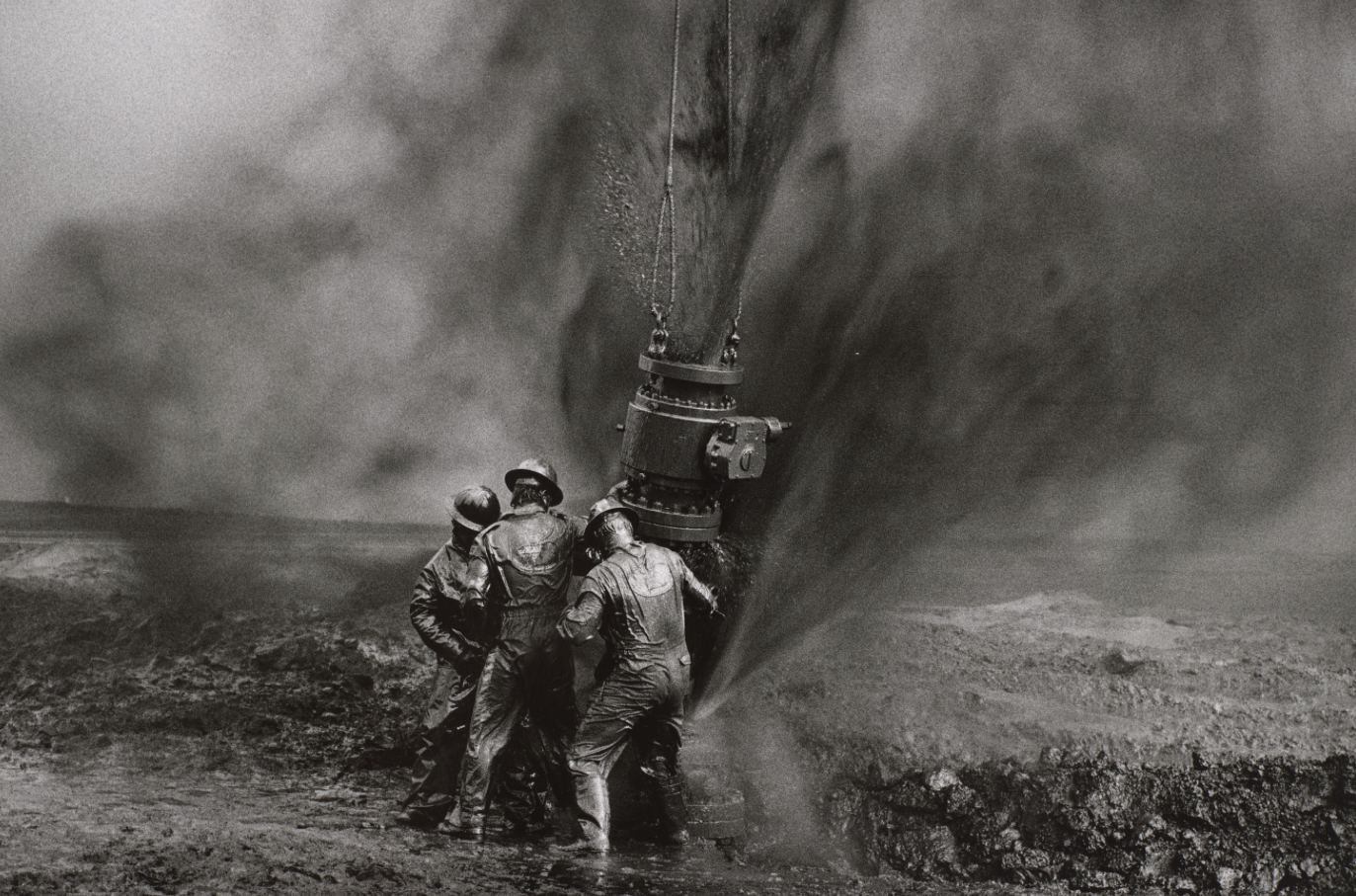   Sebastião Salgado  Brazil, born 1944   Capping a Well Head, Greater Burhan Oil Wells, Kuwait , 1991 gelatin silver print, 13 x 19 1/2 inches Promised Gift from the Judy Glickman Lauder Collection, 4.2014.6 