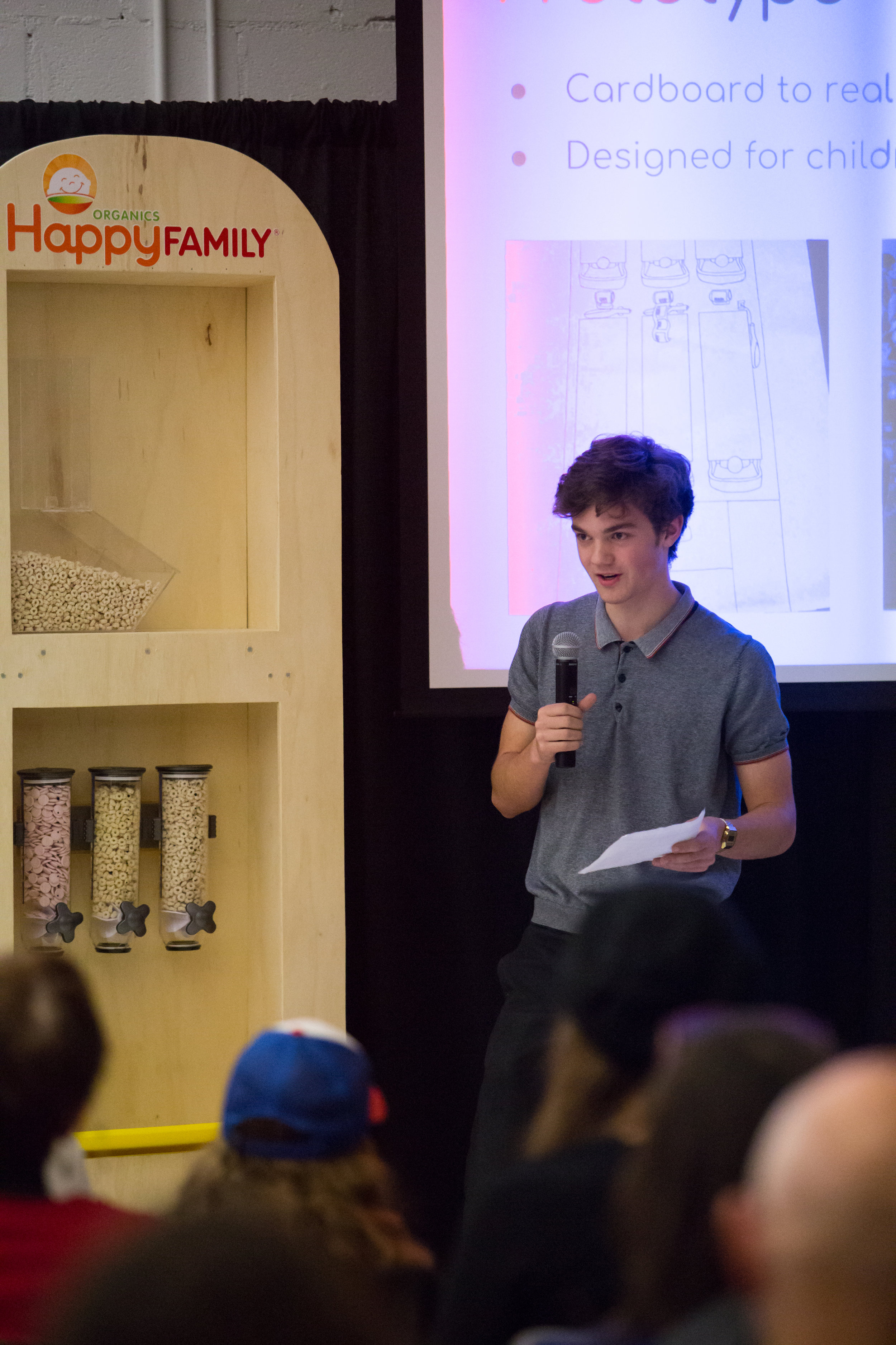  A One Stone student presents the prototype for Happy Family Organics bulk food dispensers. 