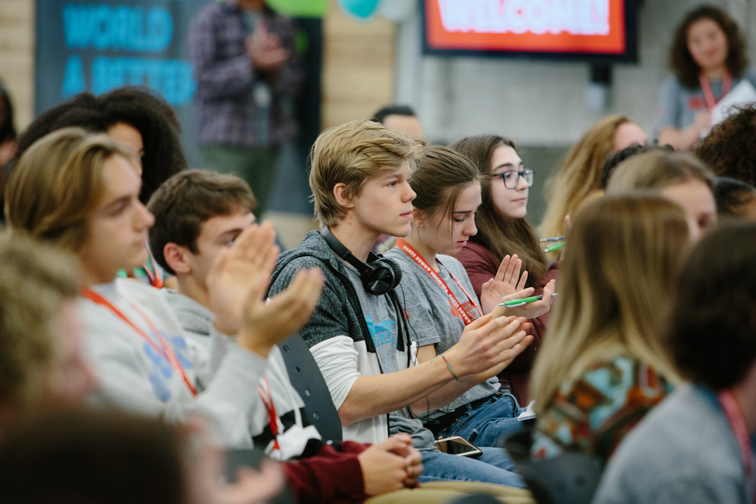  Tristan and a group of Workspace learners applaud during a Create Good presentation at the final day of Hands Down, Voices Up. 