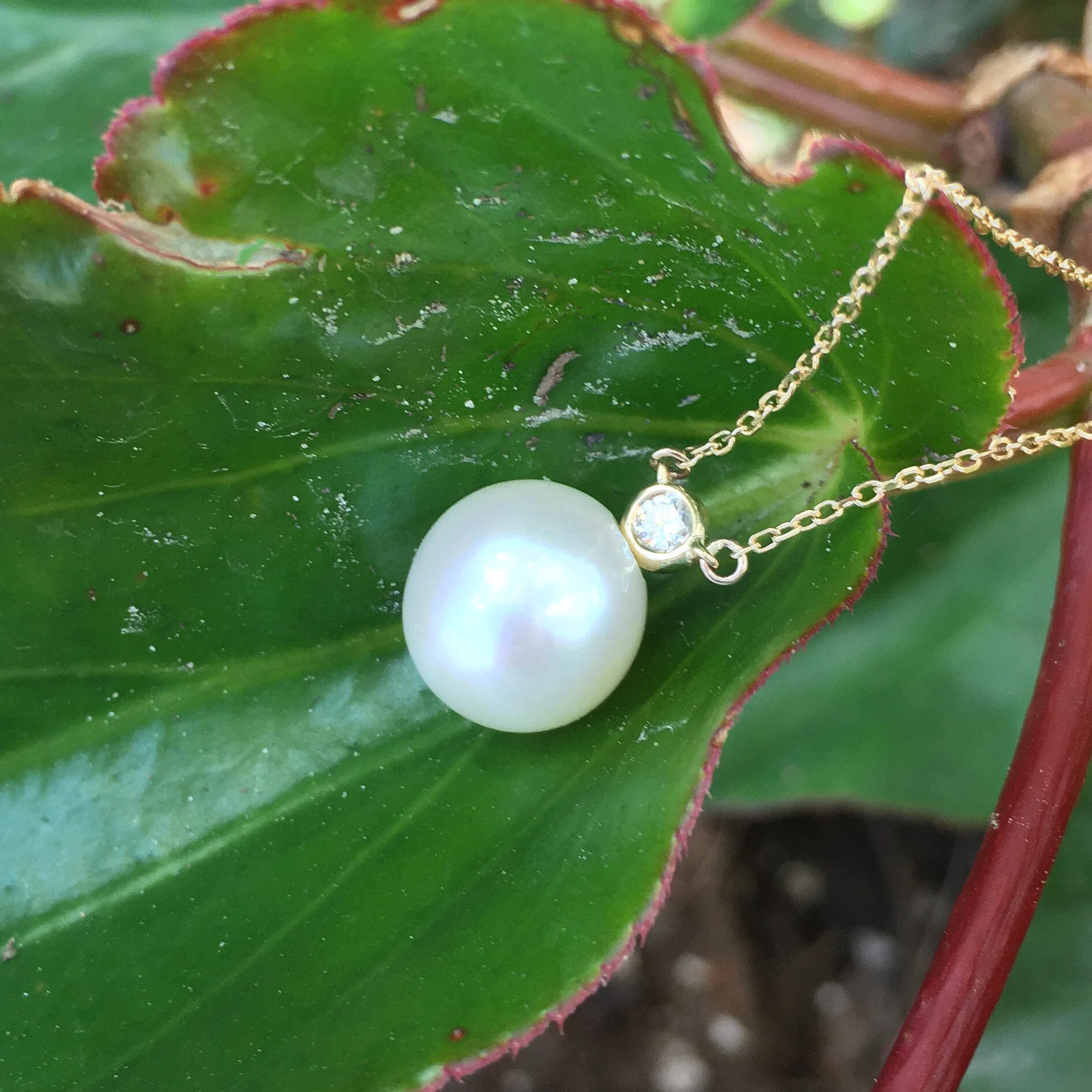 Cultured Peal Pendant with a Small Bezel Set Round Diamond 