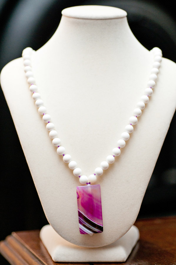  Pink-dyed quartz pendant (black stripe) with white glass  18”  $35.95 