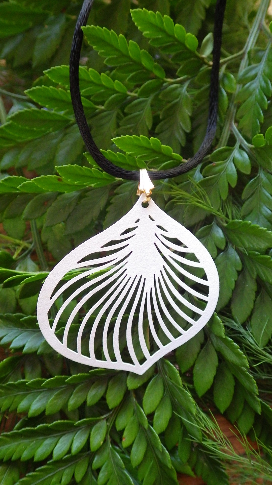  White filigree leaf (brass metal stamping) on black cold with gold clasp  18”  $19.95 