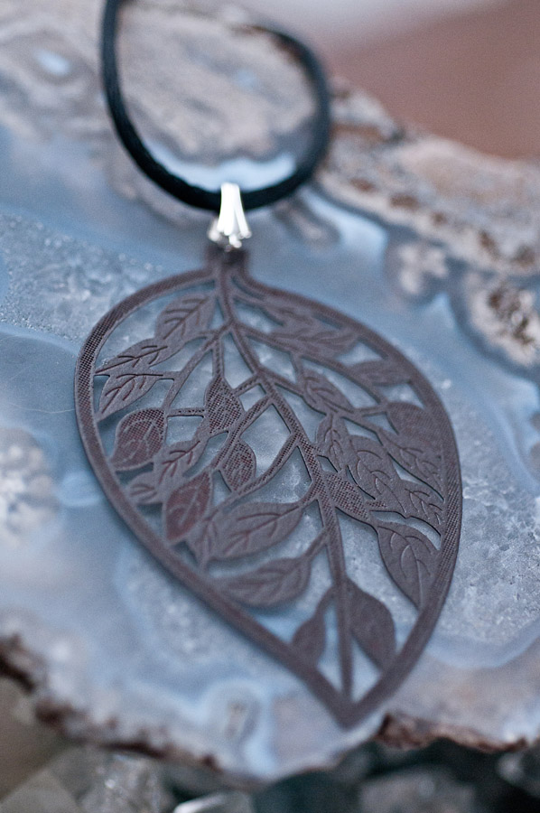  Dark brown leaf (brass metal stamping), black cord and silver findings  18”  $19.95 