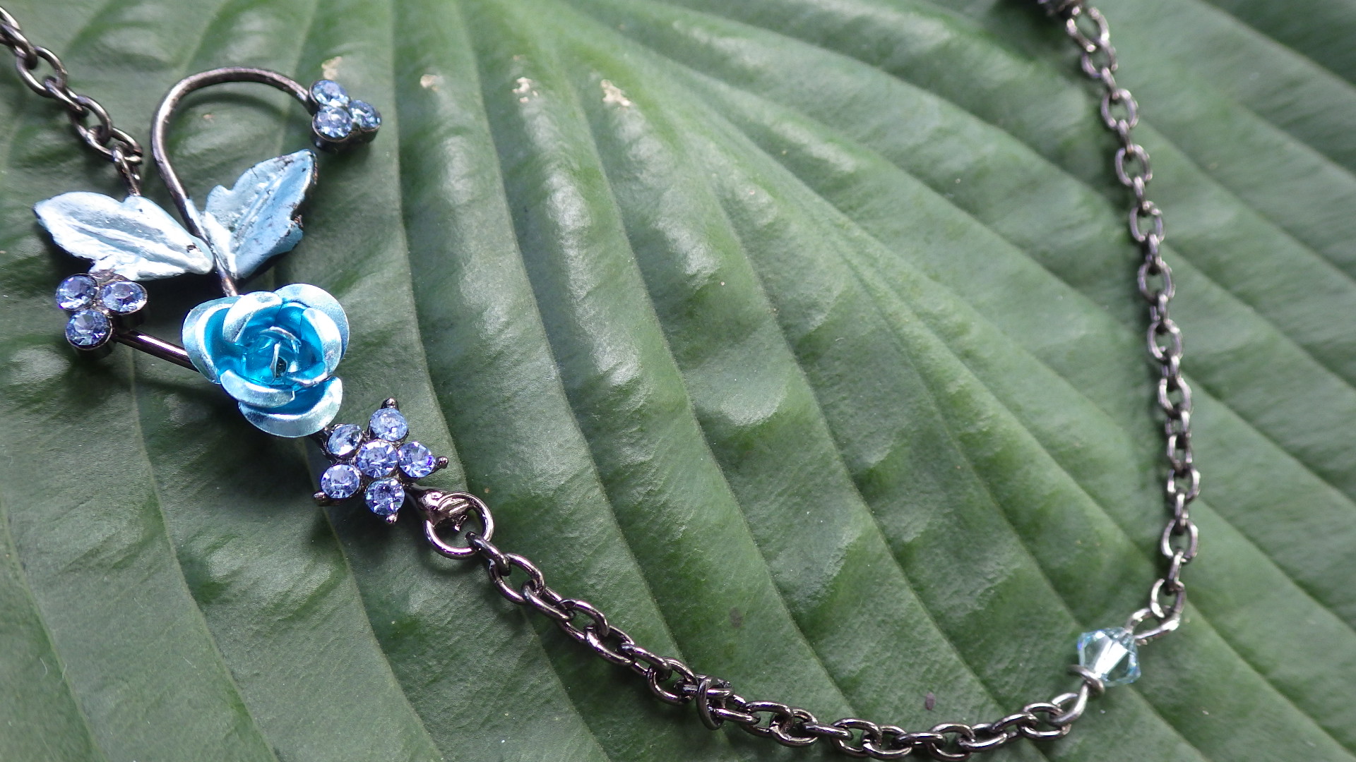  Two flowers with blue Swarovski on hematite chain  18”  $19.95 