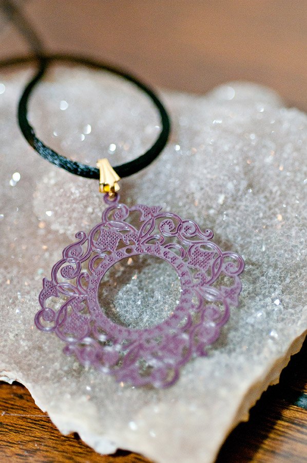  Purple filigree (brass metal stamping), black cord with gold findings  17”  $19.95 