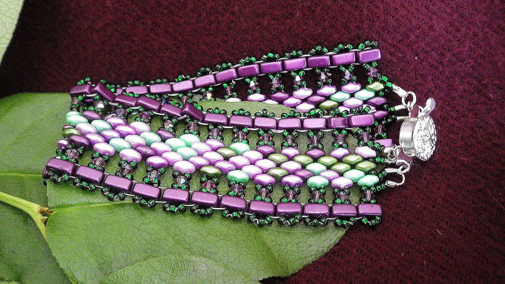  Seed bead bracelet - Purple edge, green fringe, greens/purples inside with silver findings  8.5”  $45.00 