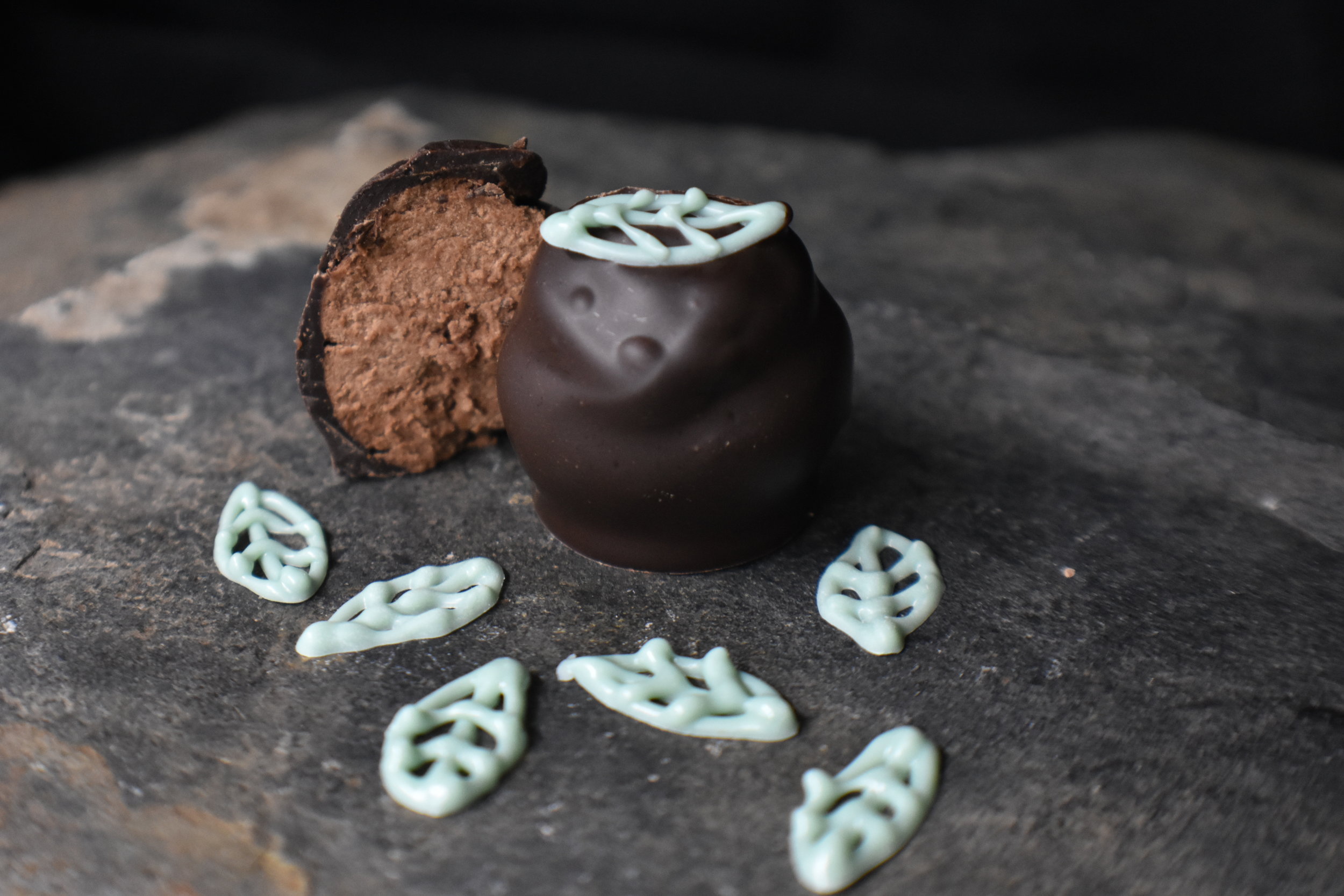 Permafrost - The bite of dark chocolate and freshness of cool mint take you to the Alaskan tundra wilds. The crispness of our mint truffle reminds us of the rock solid frozen soil nestled underneath 85% of Alaska’s land surface called permafrost; even during the summer it does not thaw. It influences Alaska’s ecosystem providing water to the soil and keeping the ground cool, while creating extremely unique tundra land forms ( ADFG - Click here for pictures and more information).