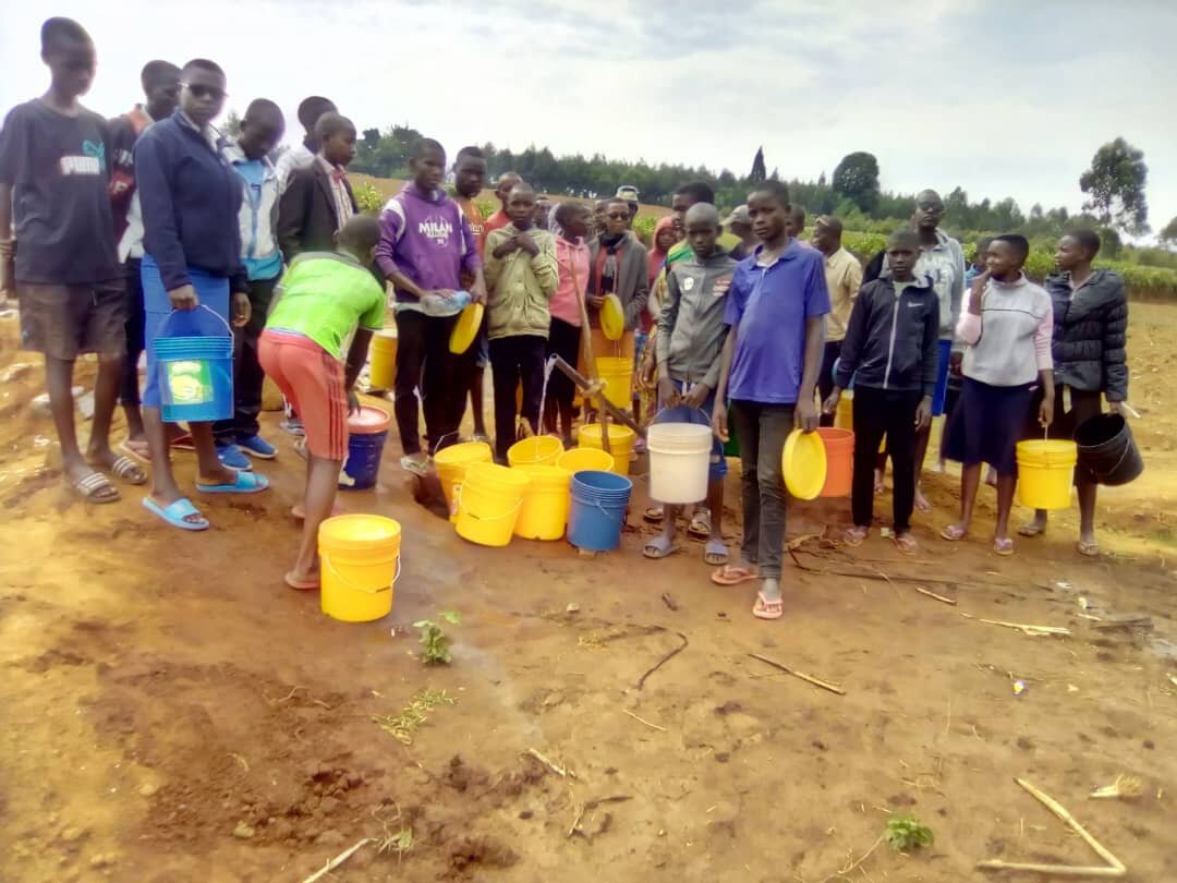 The students at Rubanga school are fetching clean water on pipeline.jpg