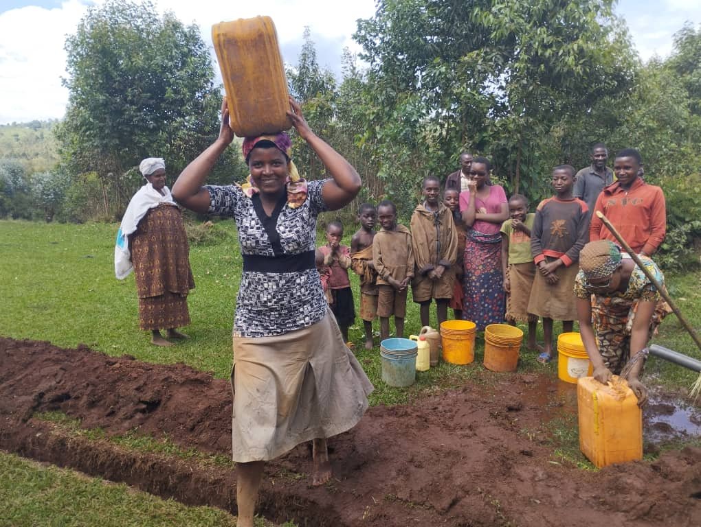 woman and children  are happy  to get clean water.jpg