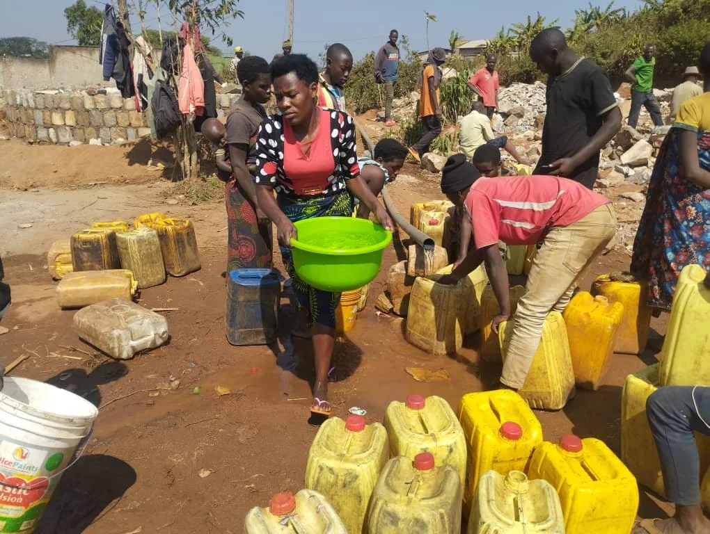 They are fetching clean water on pipeline.jpg