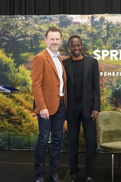Dr. Chad Whited (left) stands on stage with Gilbert Tuhabonye at the Gazelle Foundation's Spring For The Water Gala