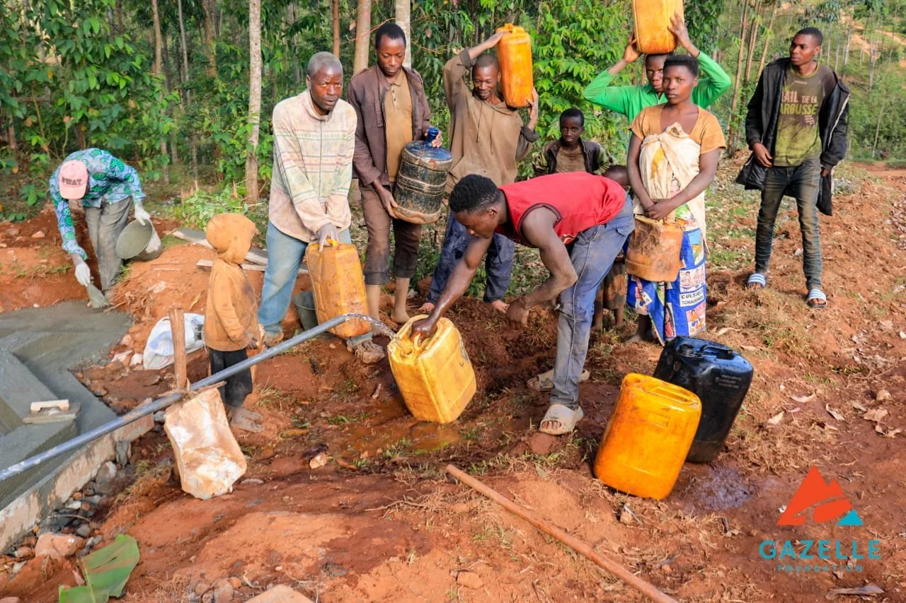 citizens accesssing clean water from pipeline of water system in burundi africa