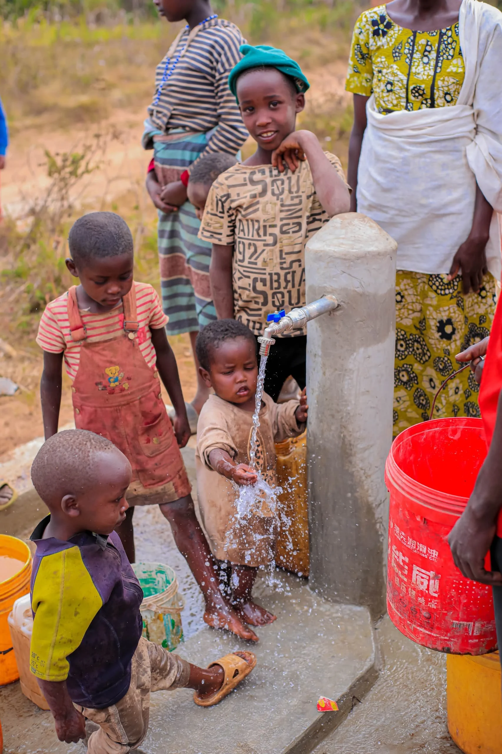 Young children at the water tap in rural Burundi