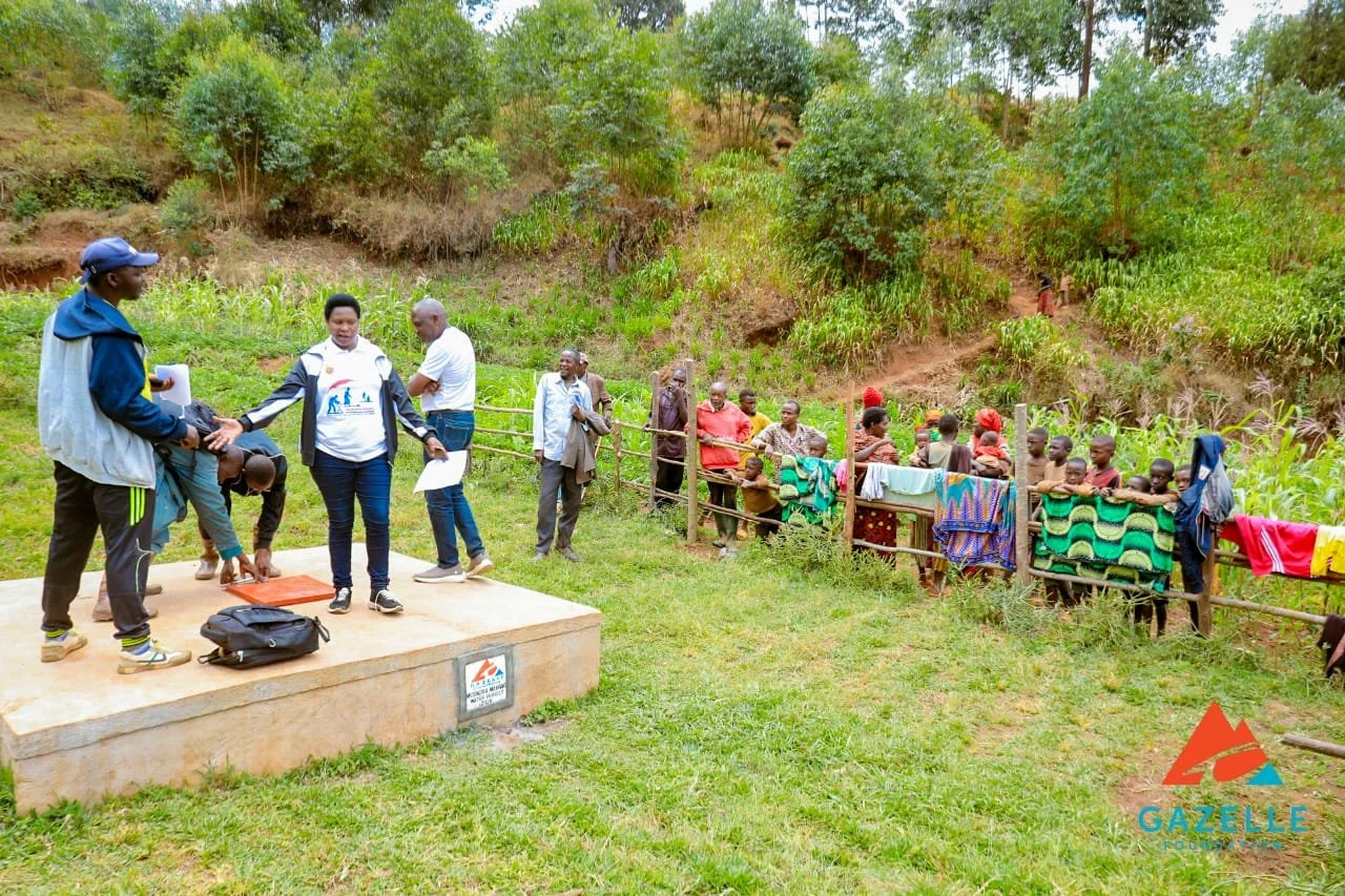 Matana administrator is happy to see the Musinzira source.jpg